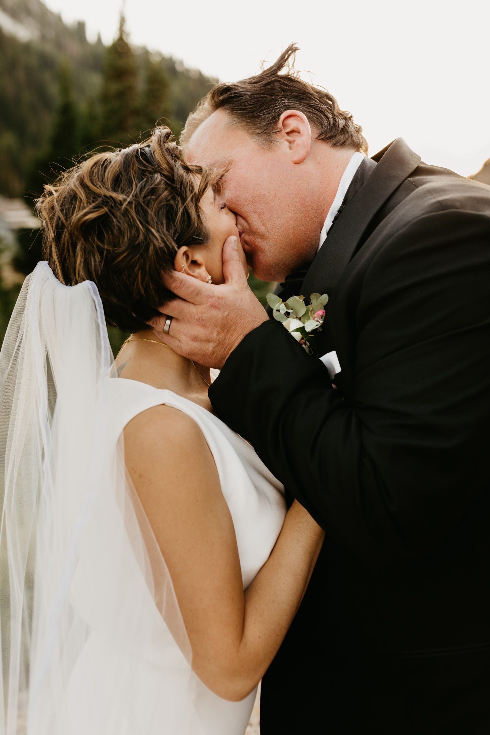 Groom Kissing Bride Alta Lodge Utah