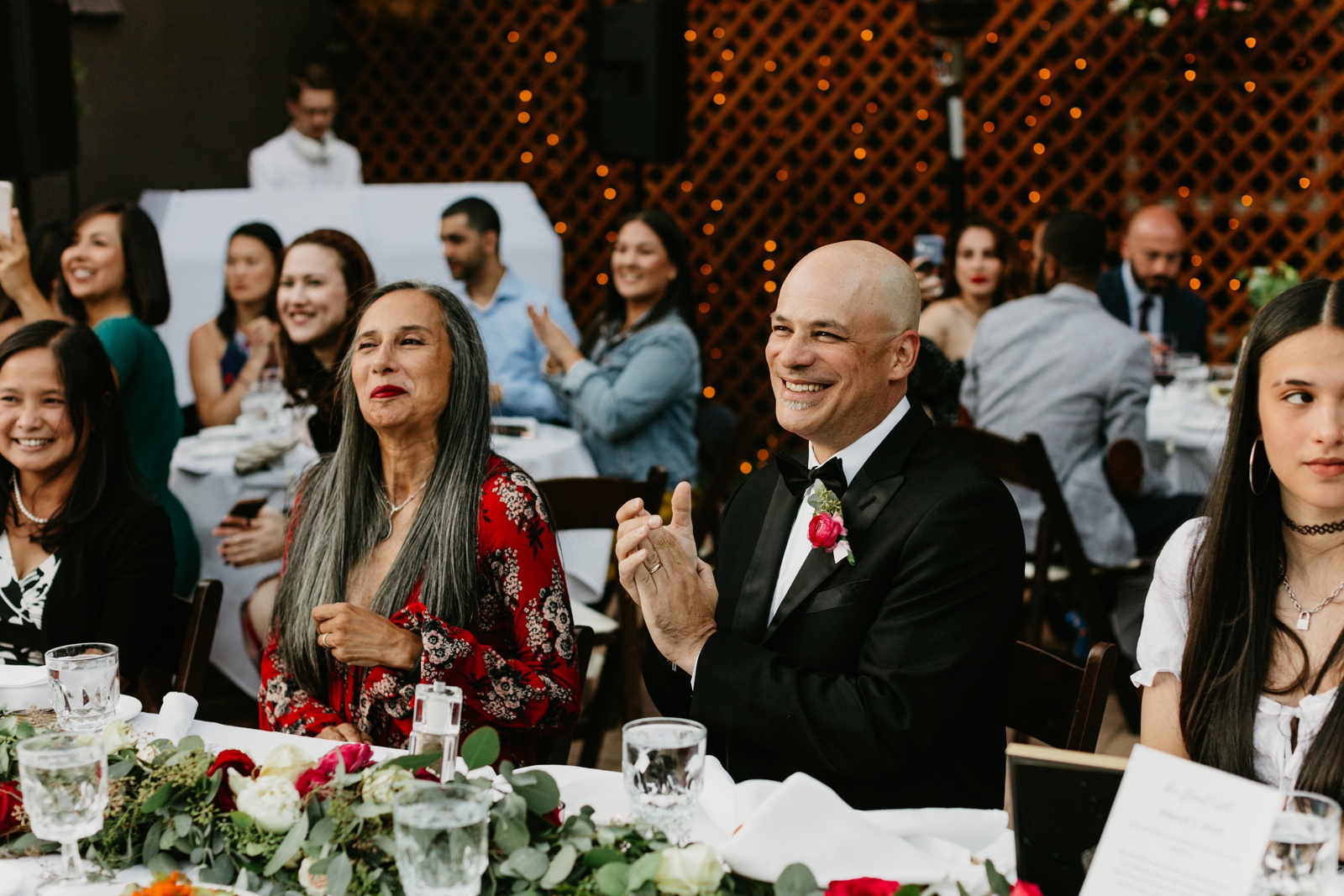 Wedding guests clapping during reception