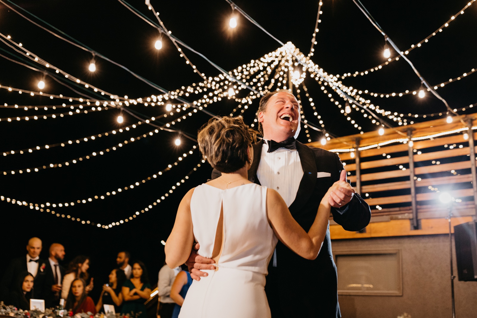 Bride and Groom First Dance Under String Lights