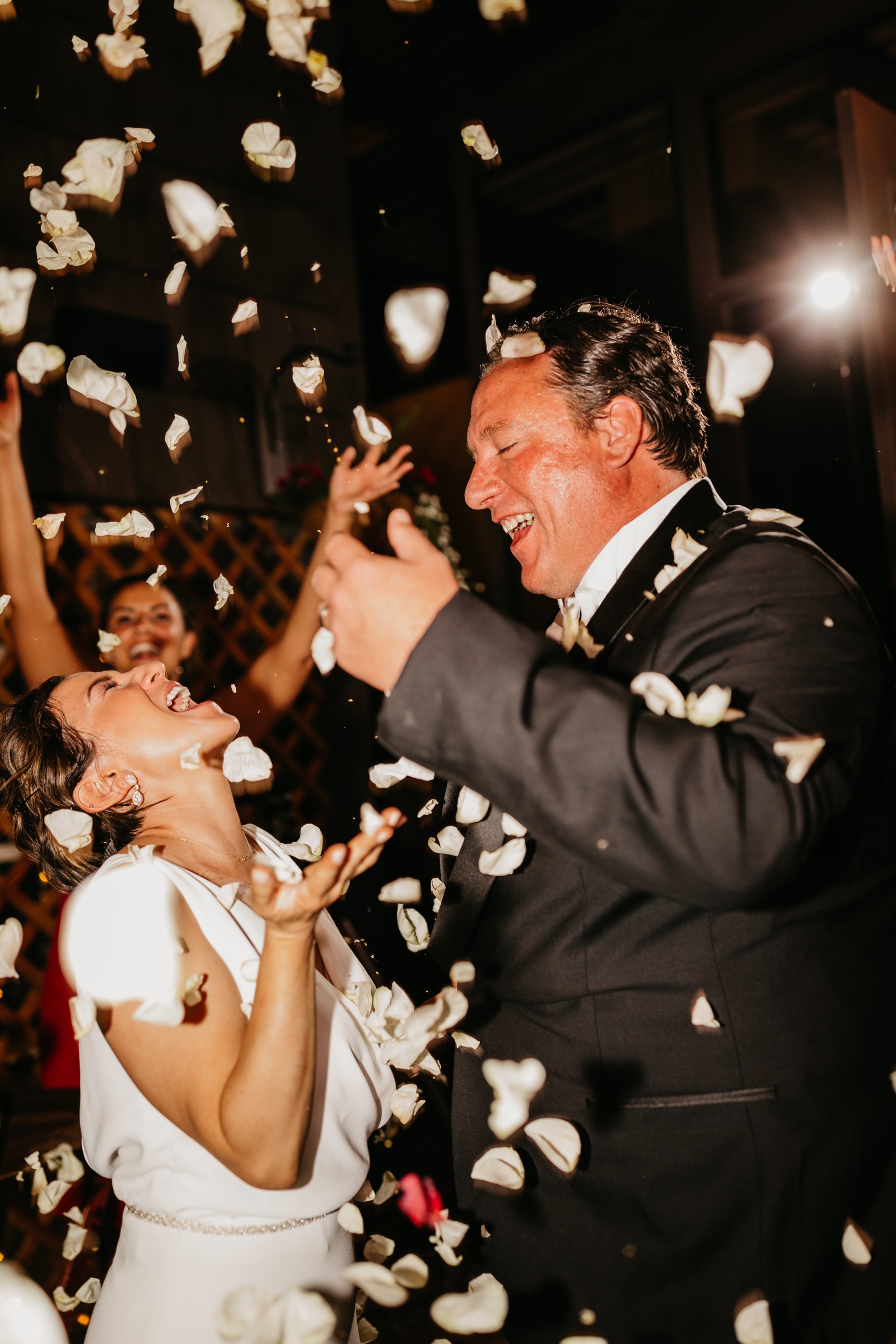 Bride and Groom Celebrating with Flower Petals