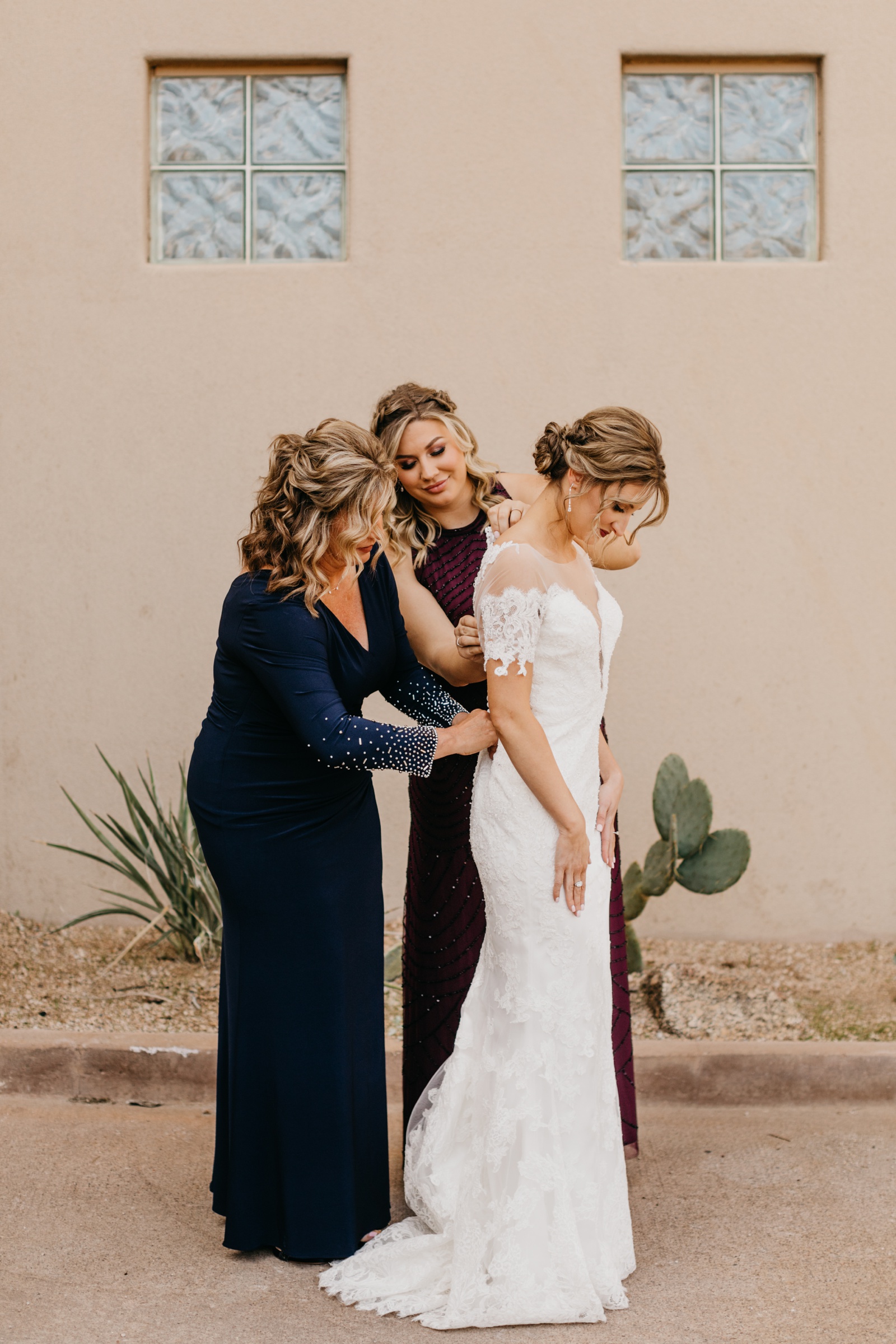 Mom zipping up bride at Scottsdale Arizona Wedding at Troon North Golf Club