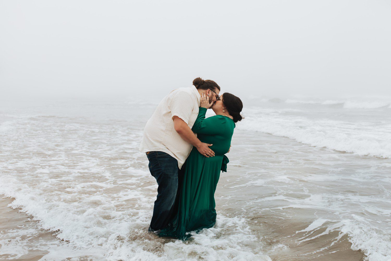 Couple kissing in ocean at Cannon Beach