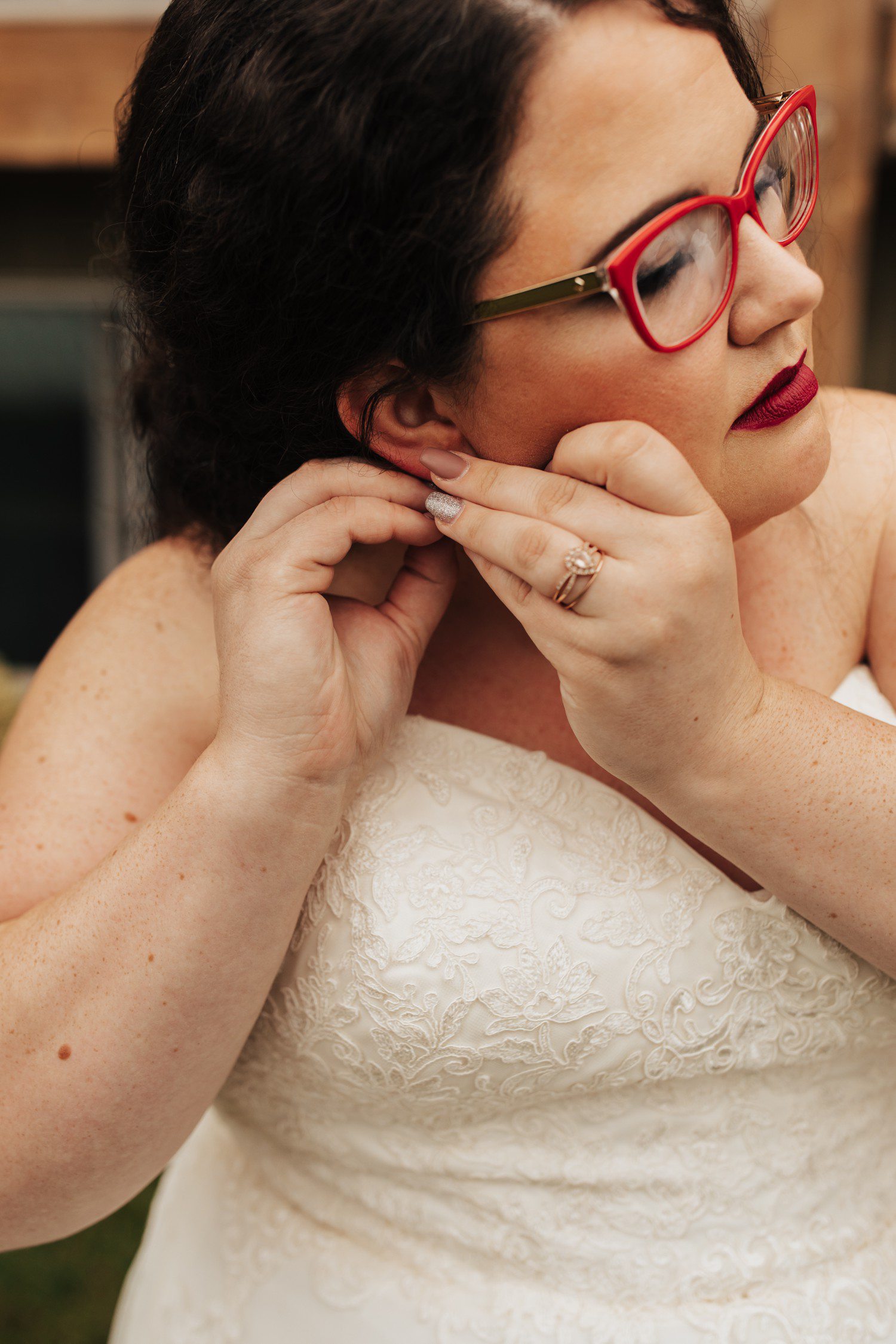Bride with red glasses getting ready