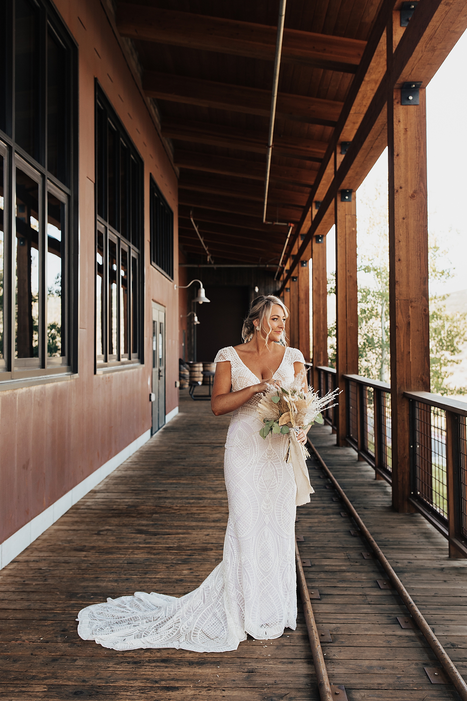 bride stands on outdoor walkway at High West in Park City, Utah