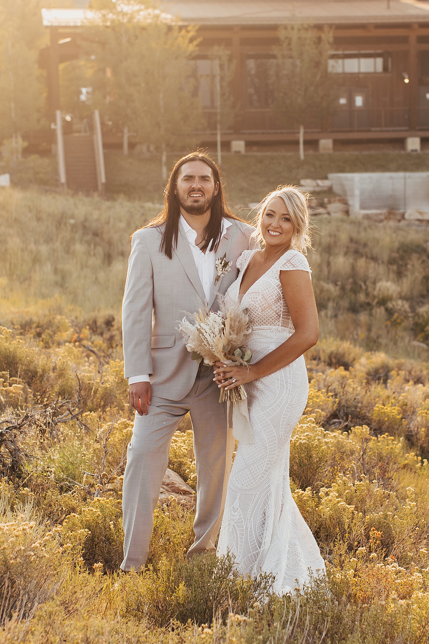 newlyweds grin in the golden hour light at High West in Park City, Utah