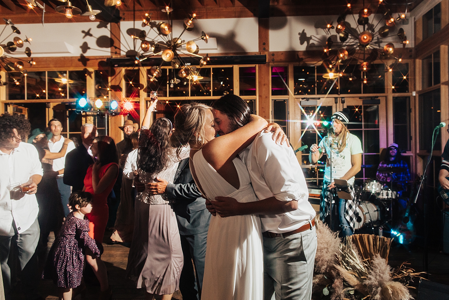 newlyweds embrace on dance floor by Nicole Aston Photography