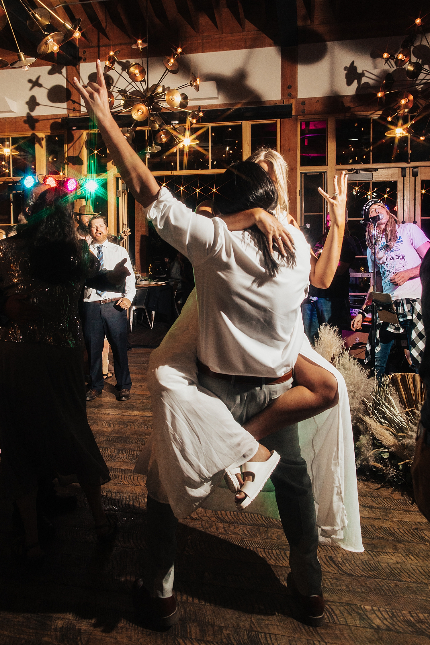 groom lifts his new wife on dance floor at High West in Park City, Utah
