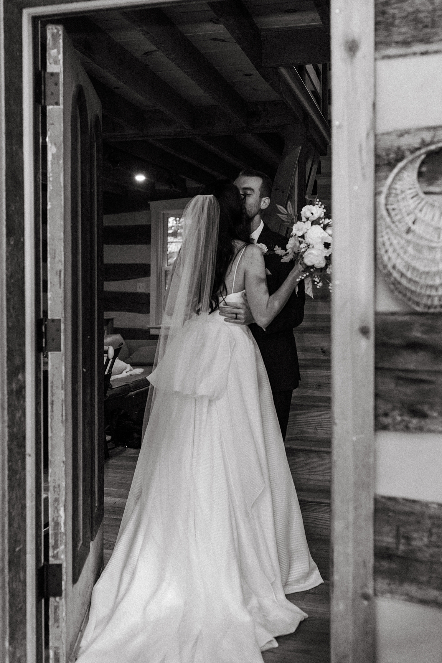 husband and wife share a kiss in cabin after ceremony for rainy autumnal intimate day