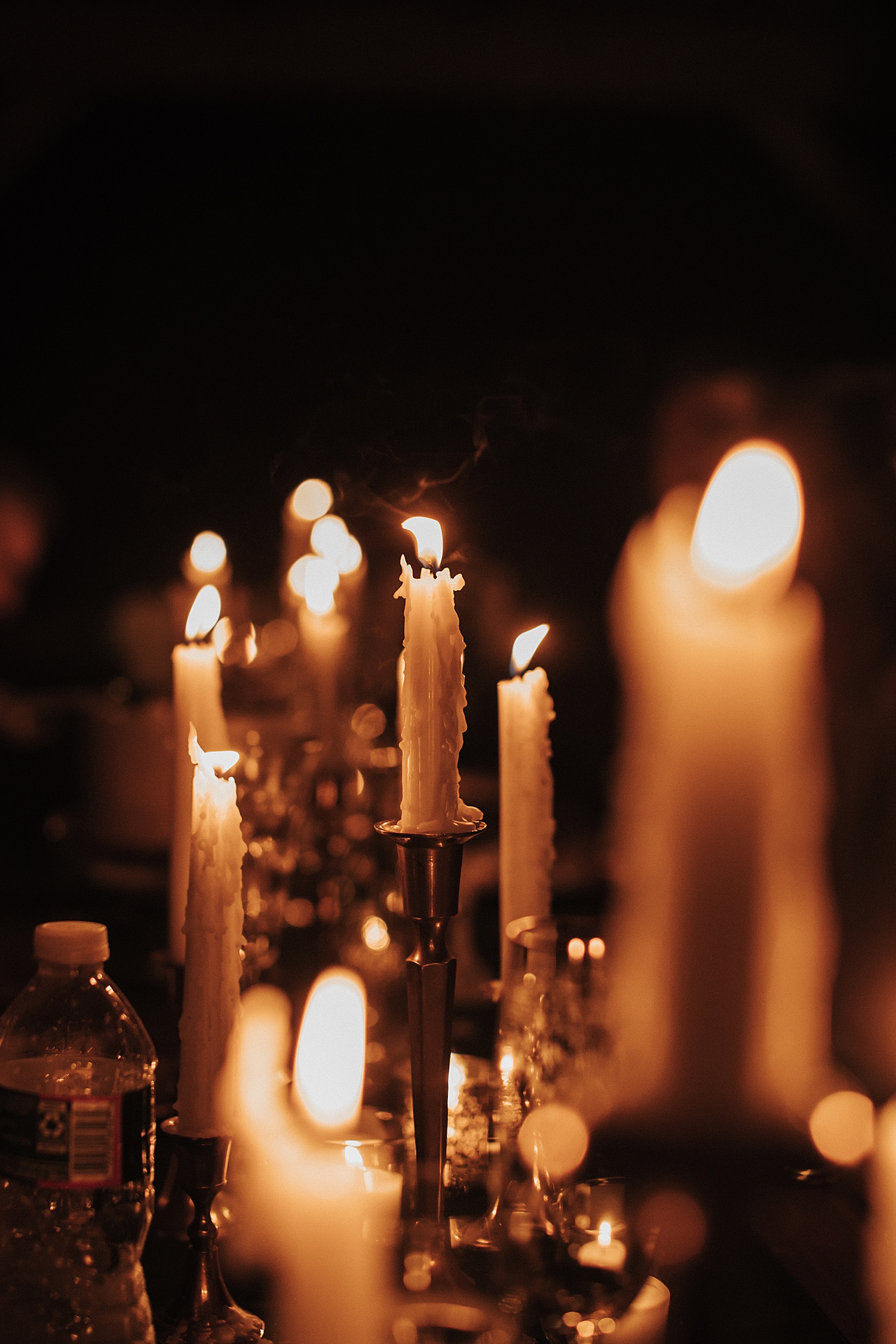 dripping lit candles in candlabras by Destination wedding photographer