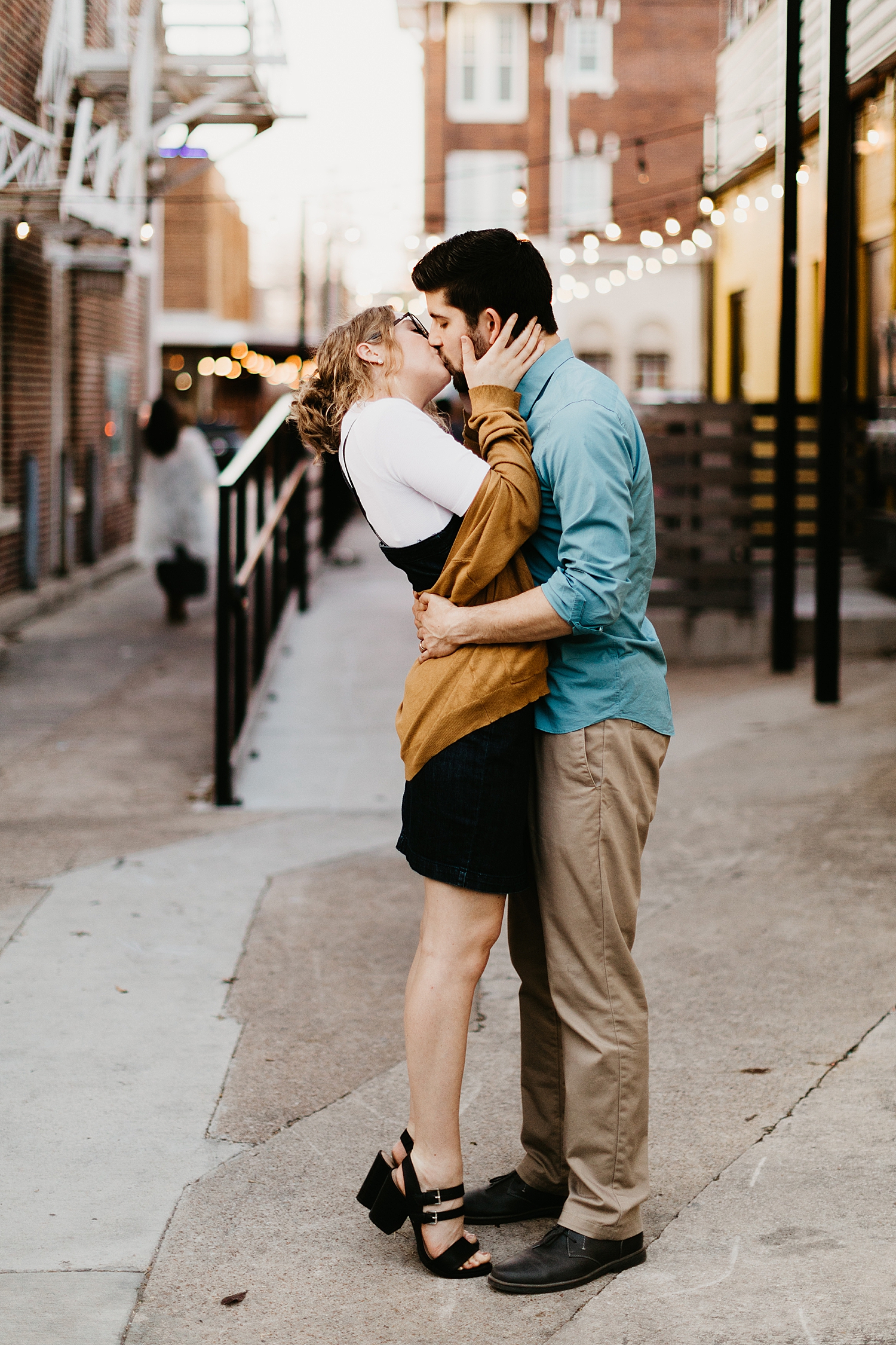 woman holds husbands face as she leans in to kiss him by Destination Wedding Photographer