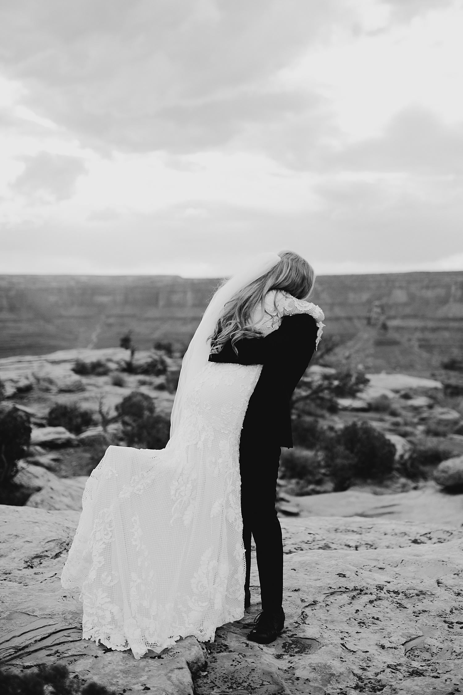 man picks up bride to spin her by Destination wedding photographer 
