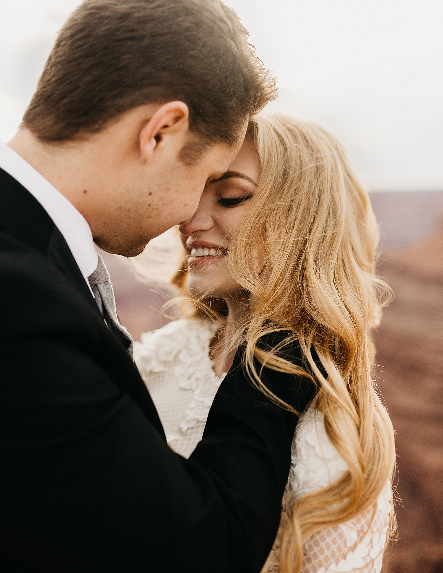 groom leans in and holds back of bride's neck for kiss by Destination wedding photographer 