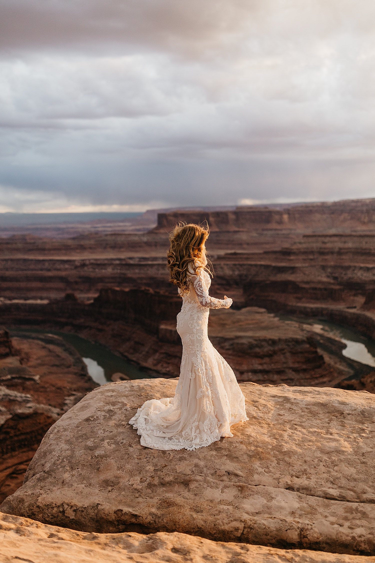 bride stands overlooking enormous canyon by Nicole Aston Photography
