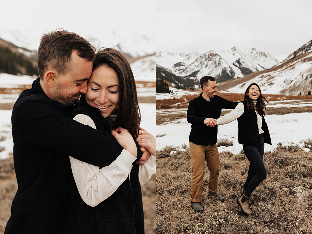 man and woman dance in front of the mountains showing 3 tips for engagement photos in the snow