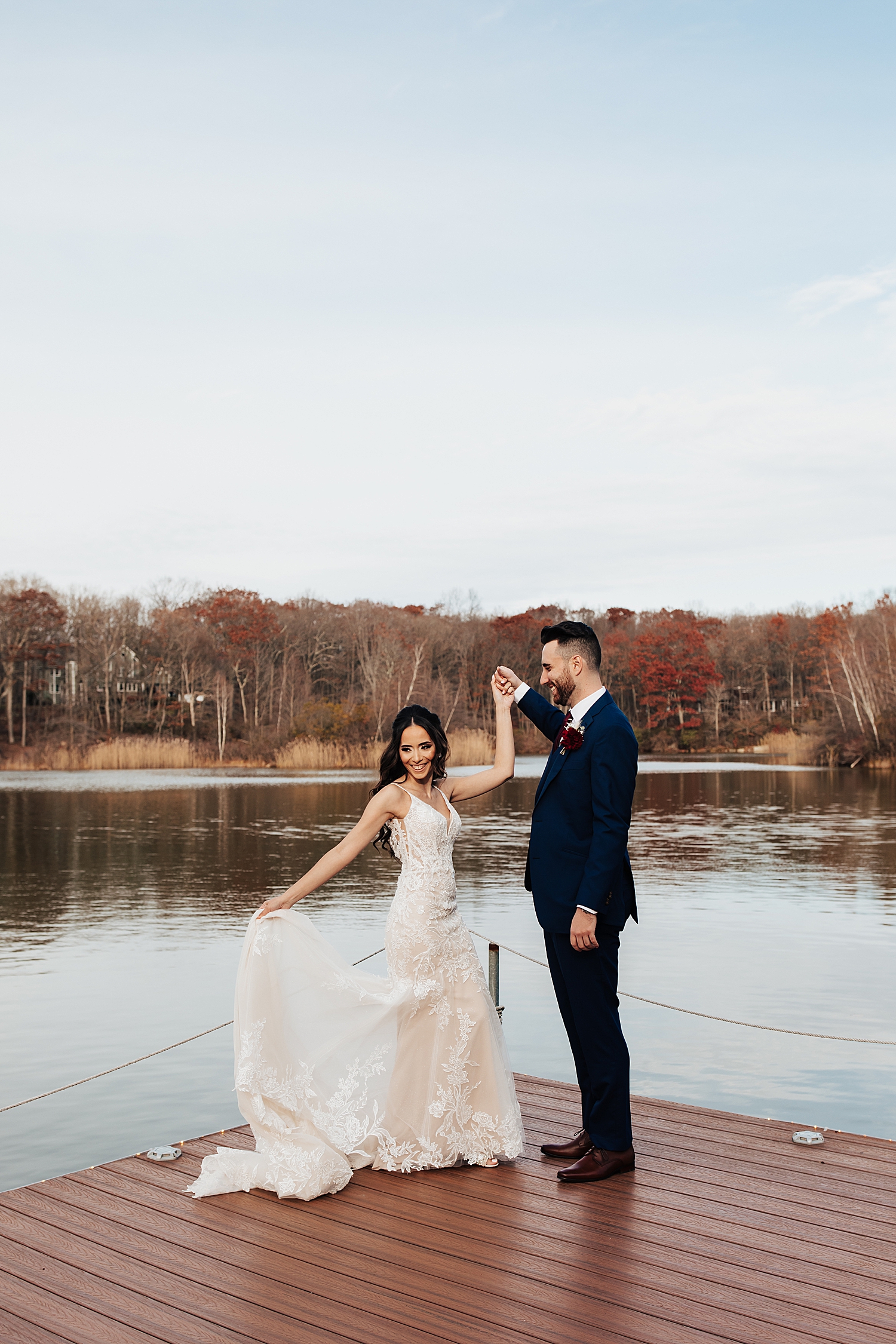man spins his new wife on dock over water for Moody Wedding in New Jersey