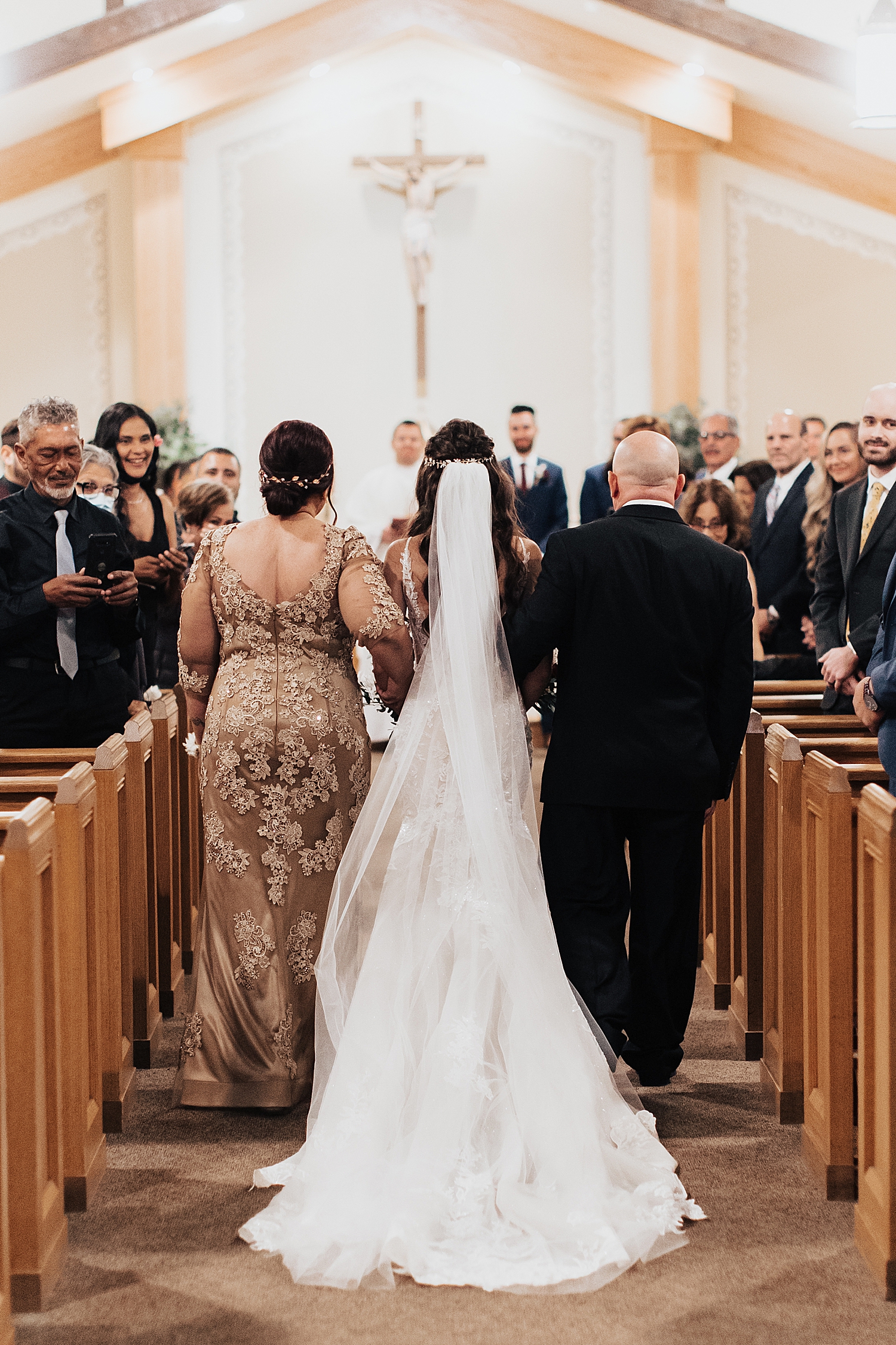 bride walks down the aisle with her parents by Nicole Aston Photo