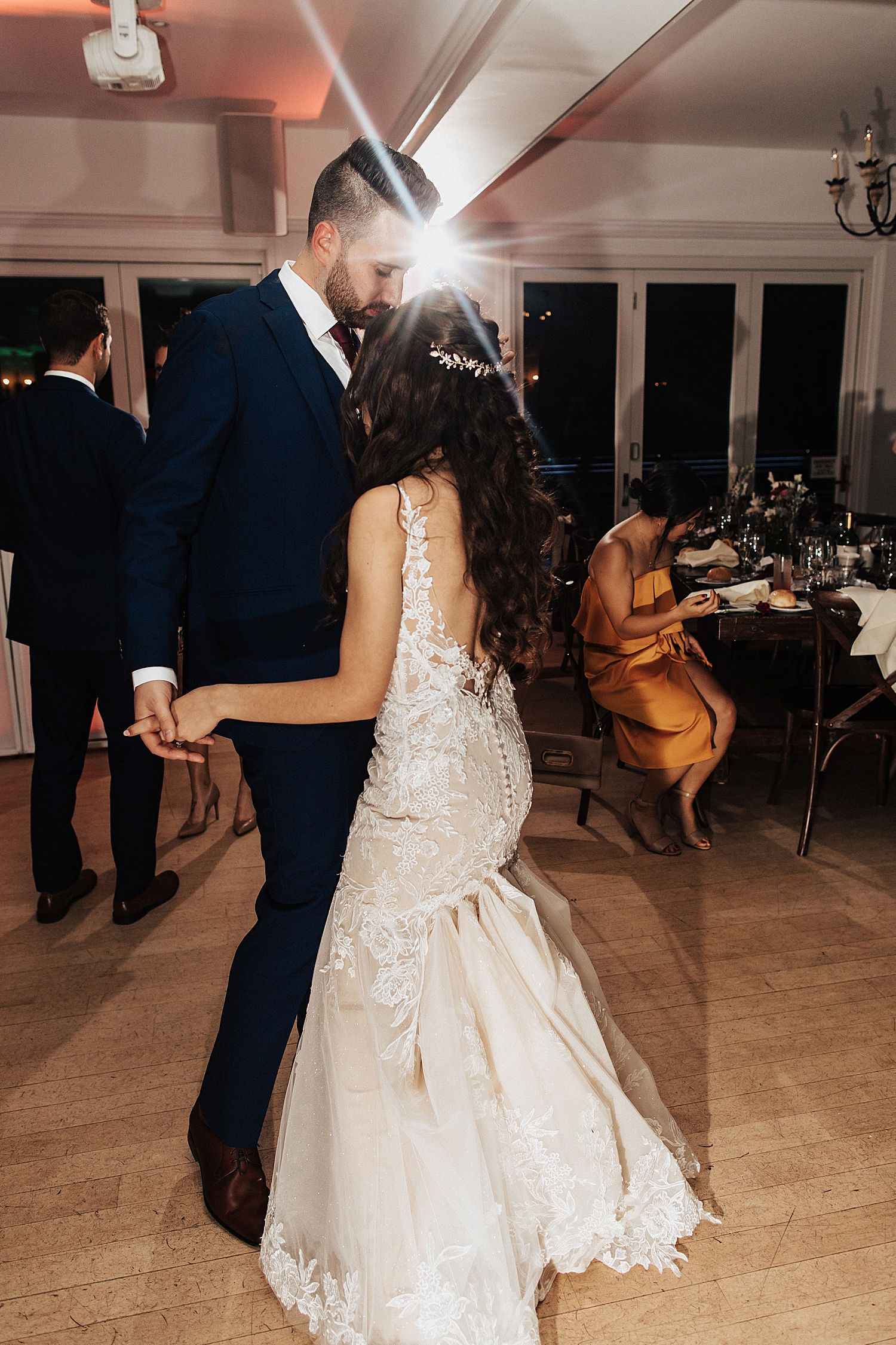 newlyweds share a first dance in front of their guests by Nicole Aston Photo