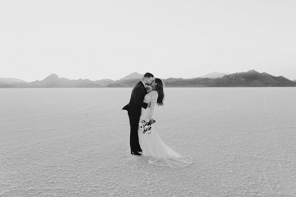 man and woman stand in open area for kiss by Destination wedding photographer