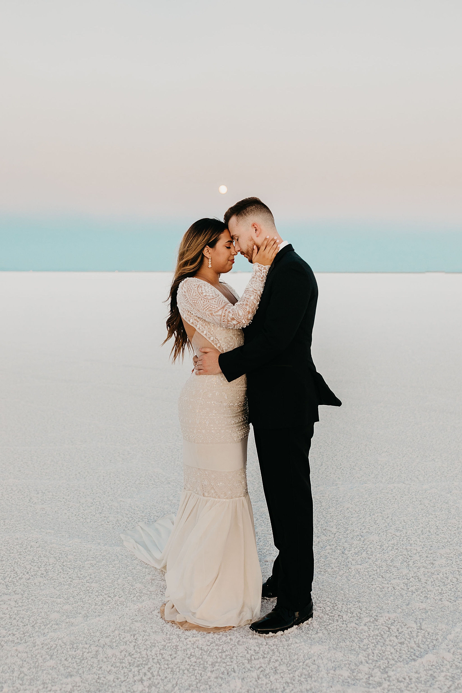 couple embrace on salt flats for their First Look + Bridal Session