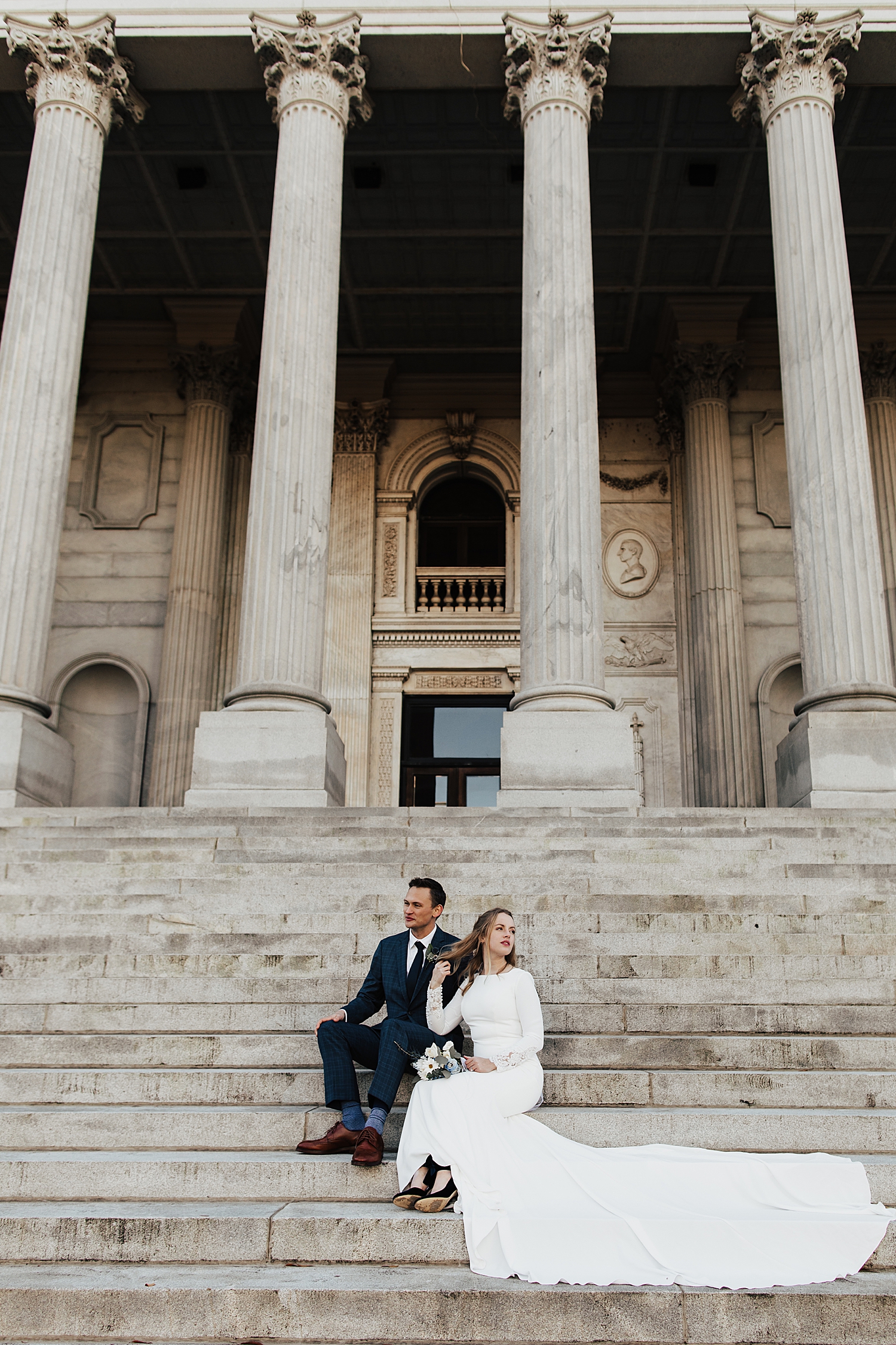 husband and wife-to-be sit on old stone steps by Nicole Aston Photography