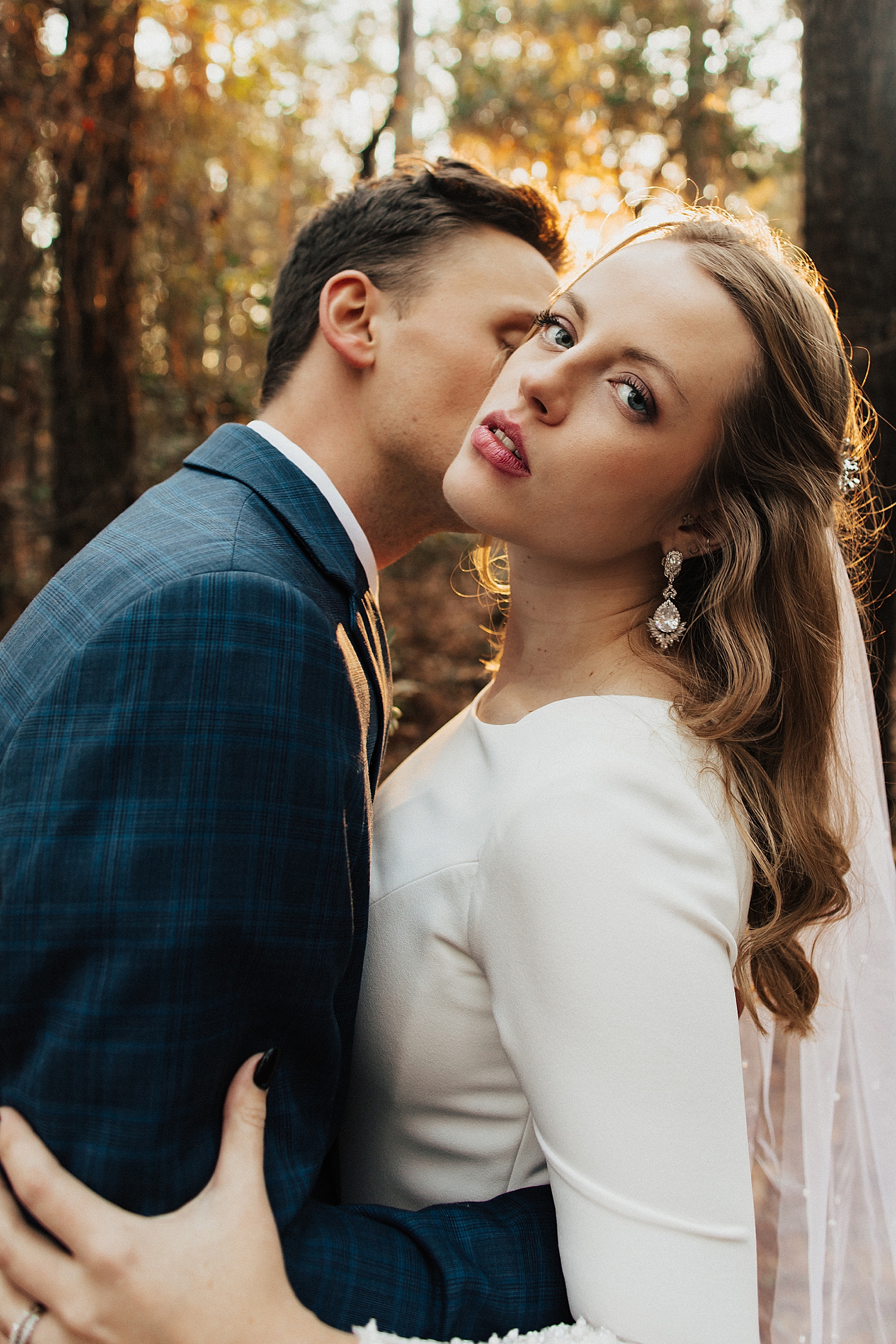 blonde bride leans back as man kisses her neck by Nicole Aston Photography