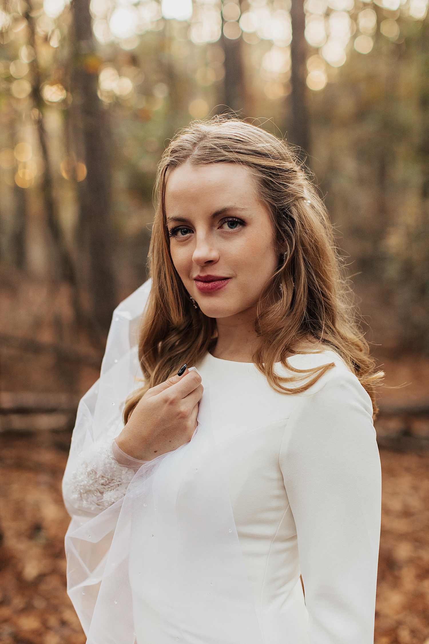 woman with red lipstick and white dress under trees by Nicole Aston Photography