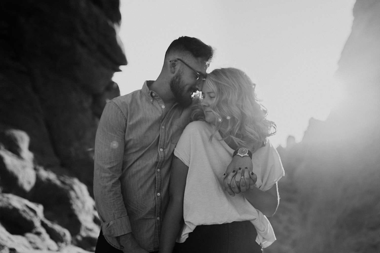man snuggles his woman in glowy evening light by Destination wedding photographer