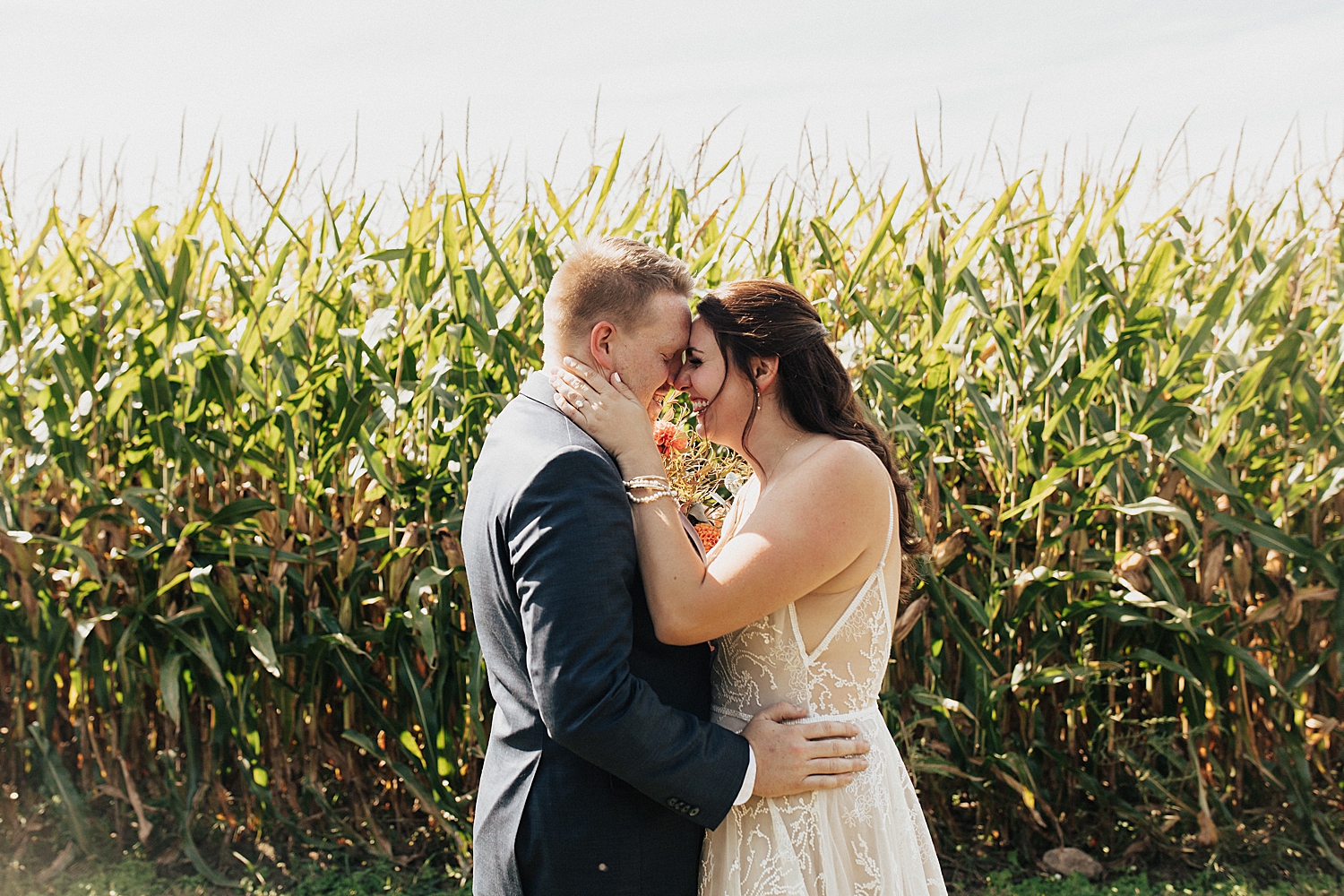 brunette woman holds her groom close by Nicole Aston Photography