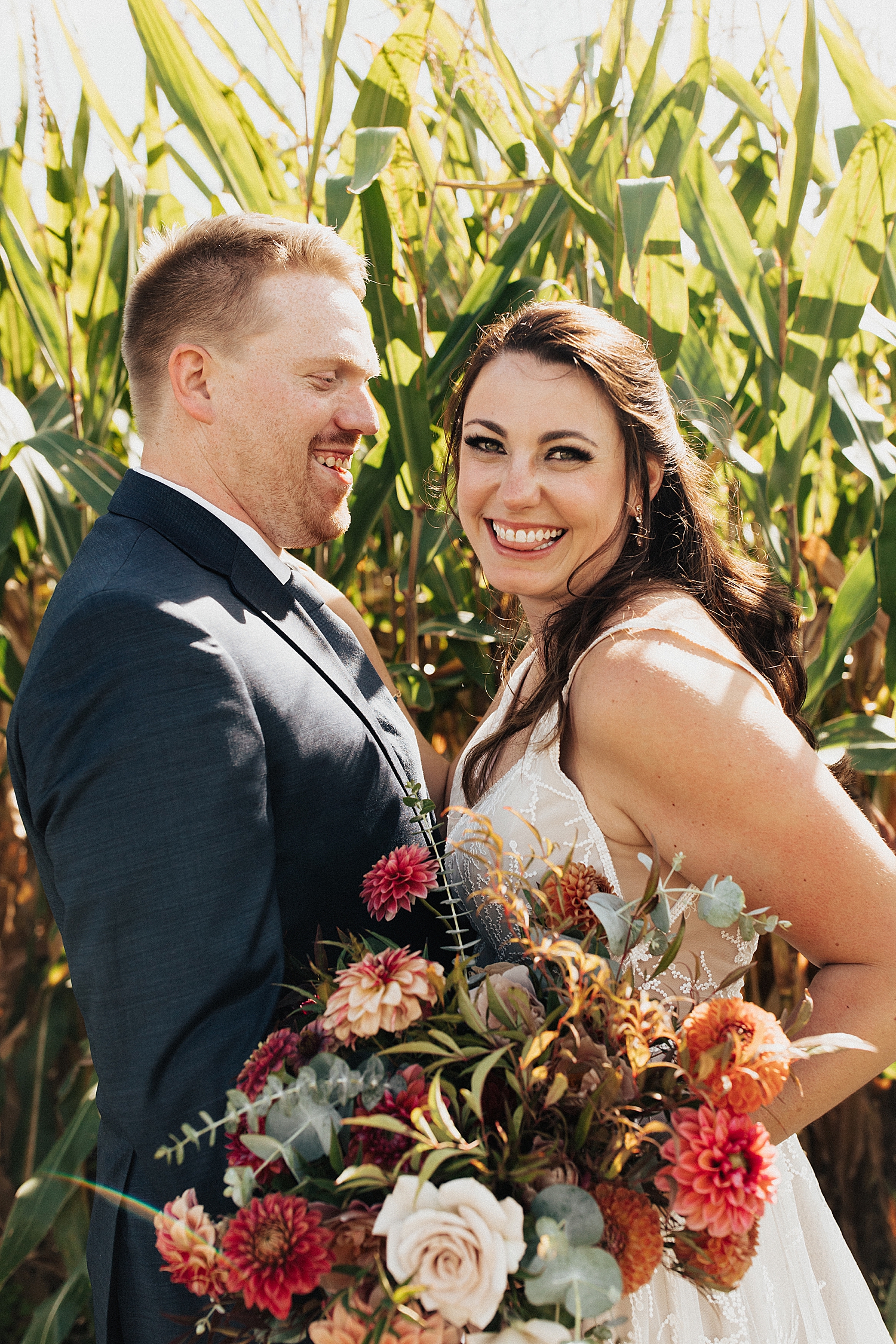 couple embrace in a field for first look by Destination wedding photographer