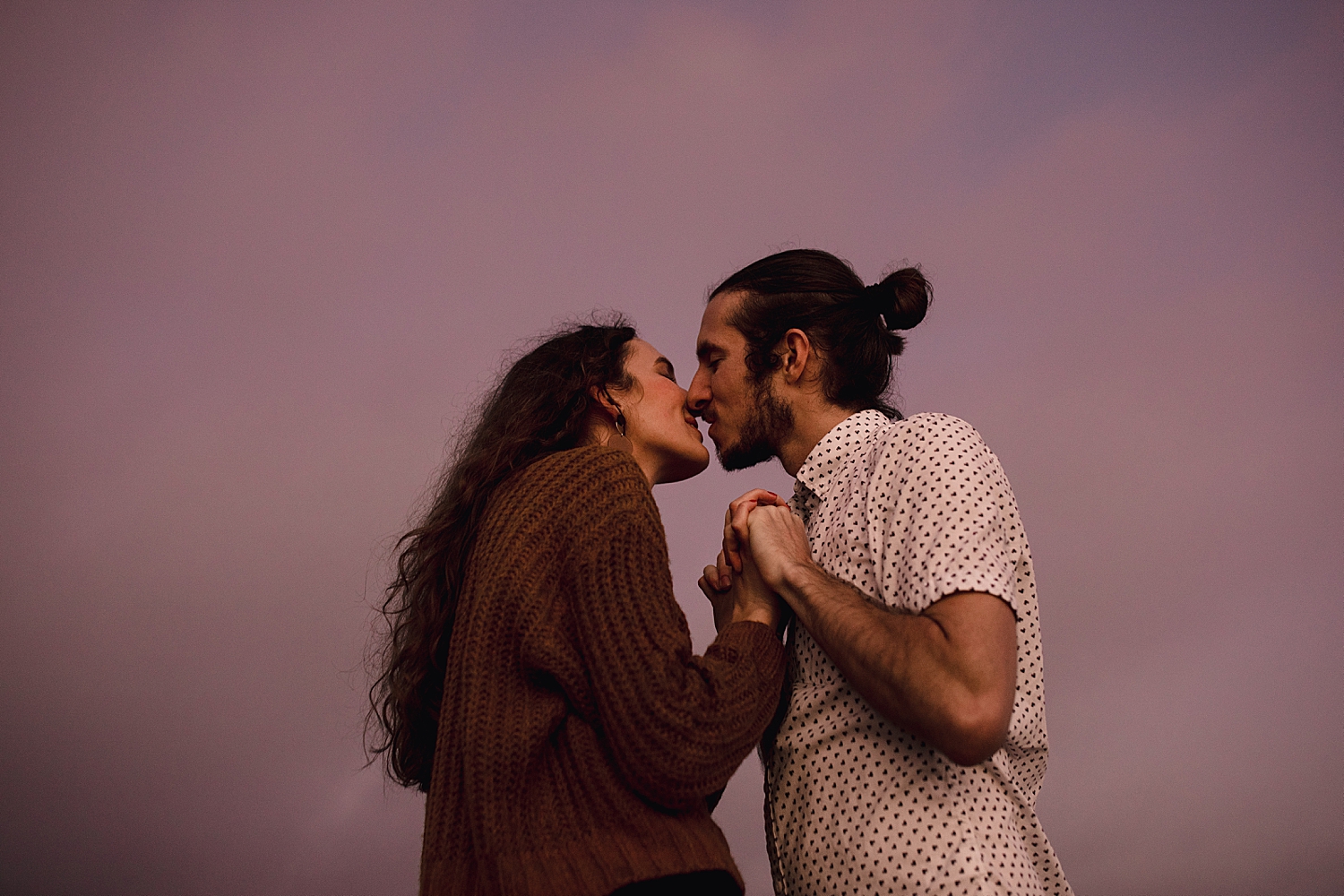 man and woman about to kiss under purple skies by Nicole Aston Photography for their Venice Beach session