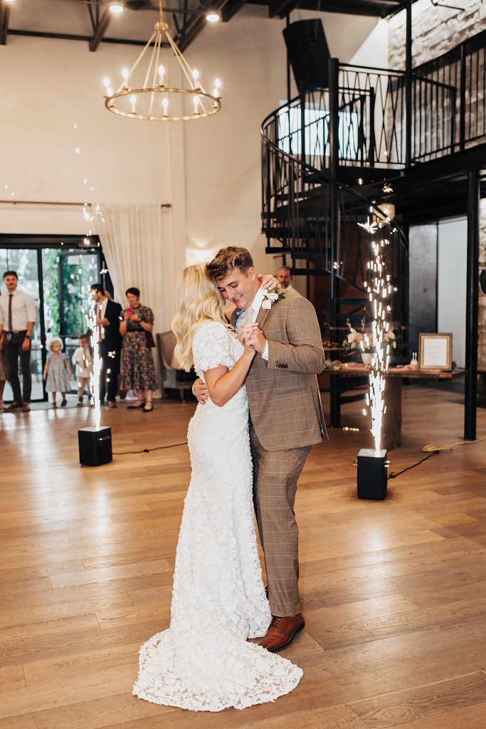newlyweds share a first dance in front of sparklers by Destination wedding photographer