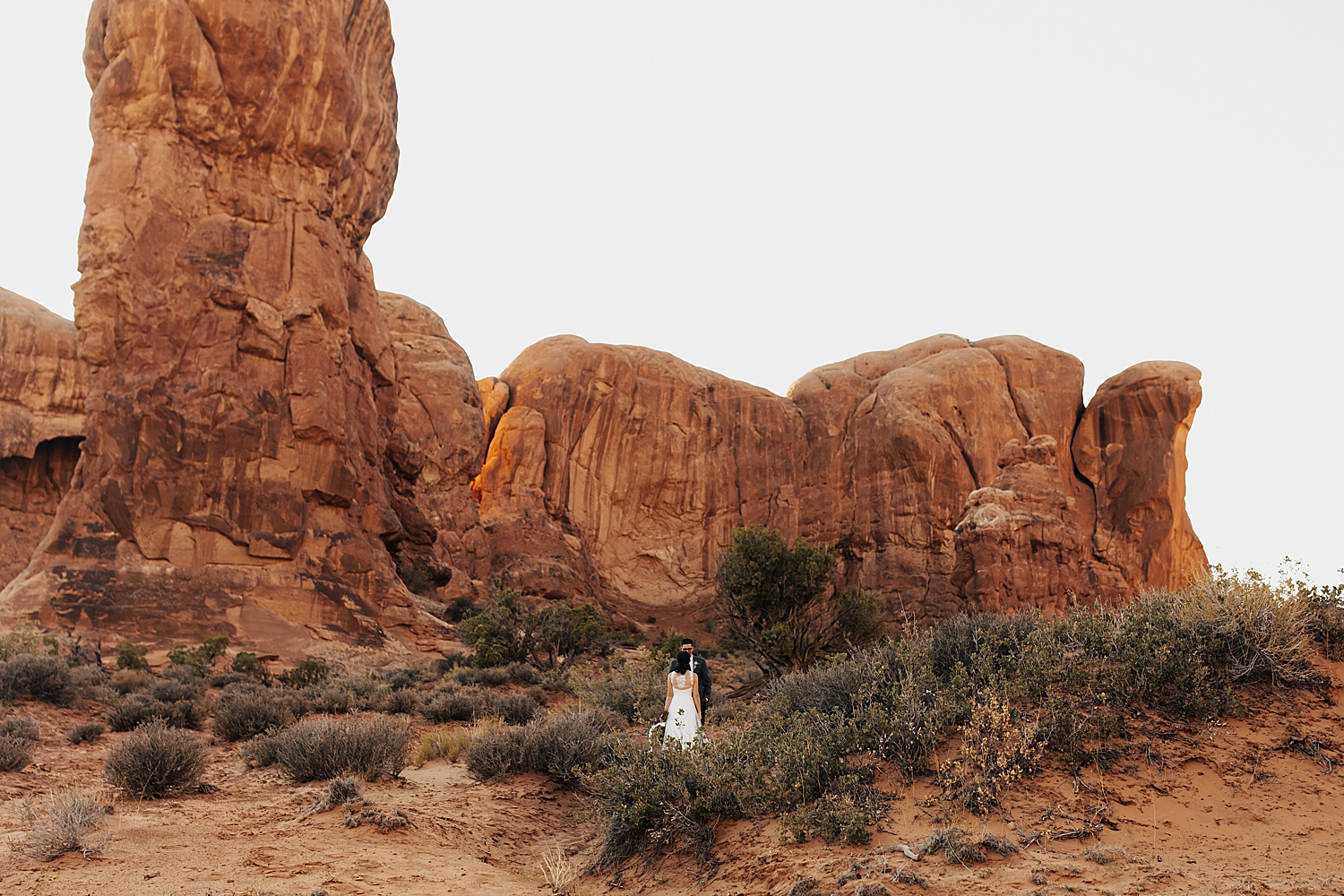 man and woman share a kiss in rugged terrain by Nicole Aston Photography