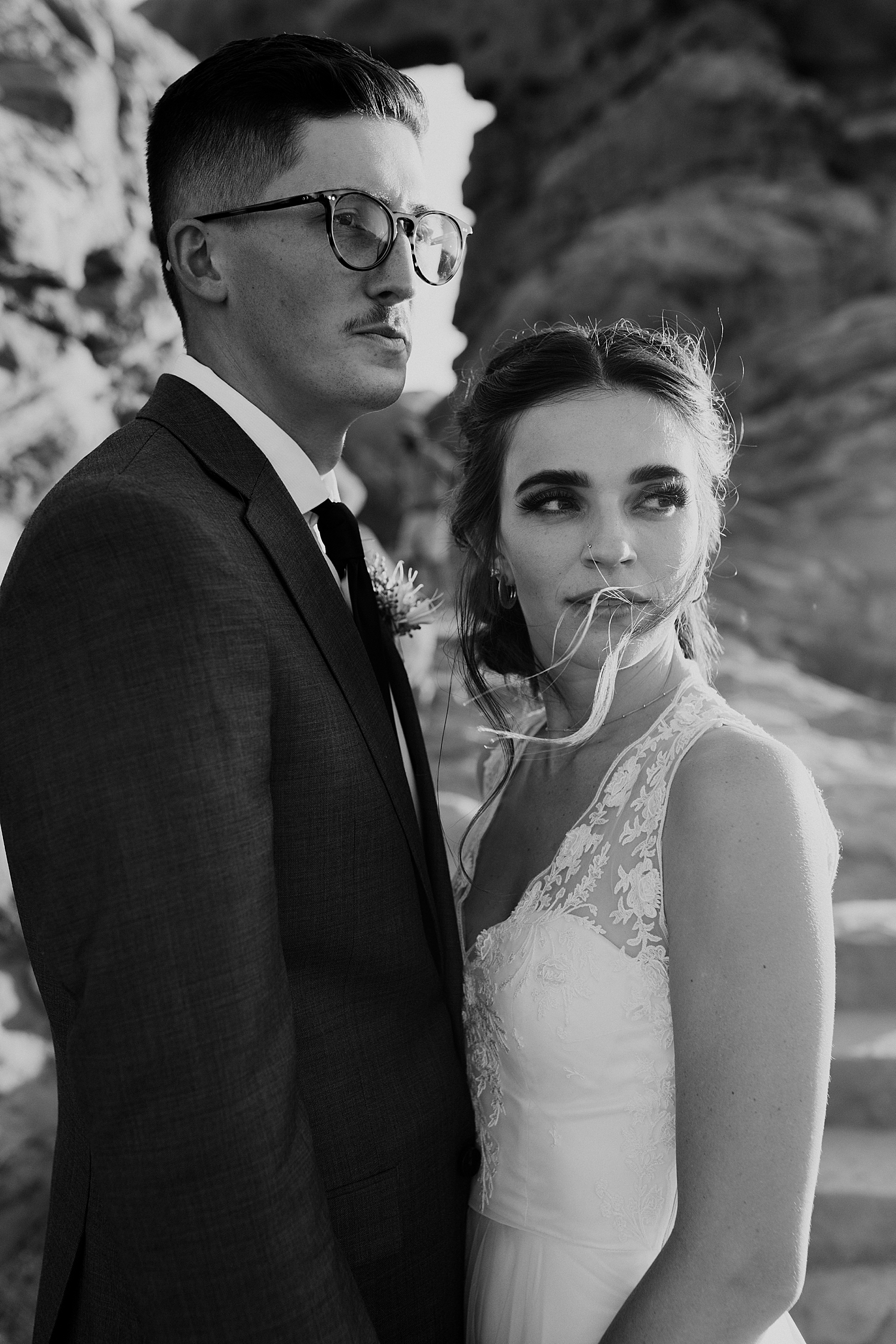 newlyweds stand close and look off into the distance by Destination elopement photographer
