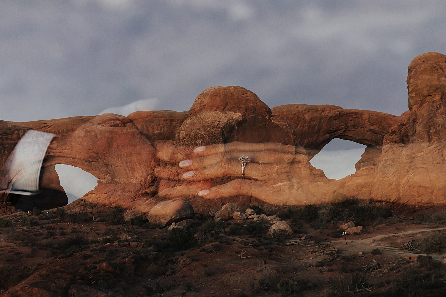 couple hold hands in front of the arches for Moab wedding portraits