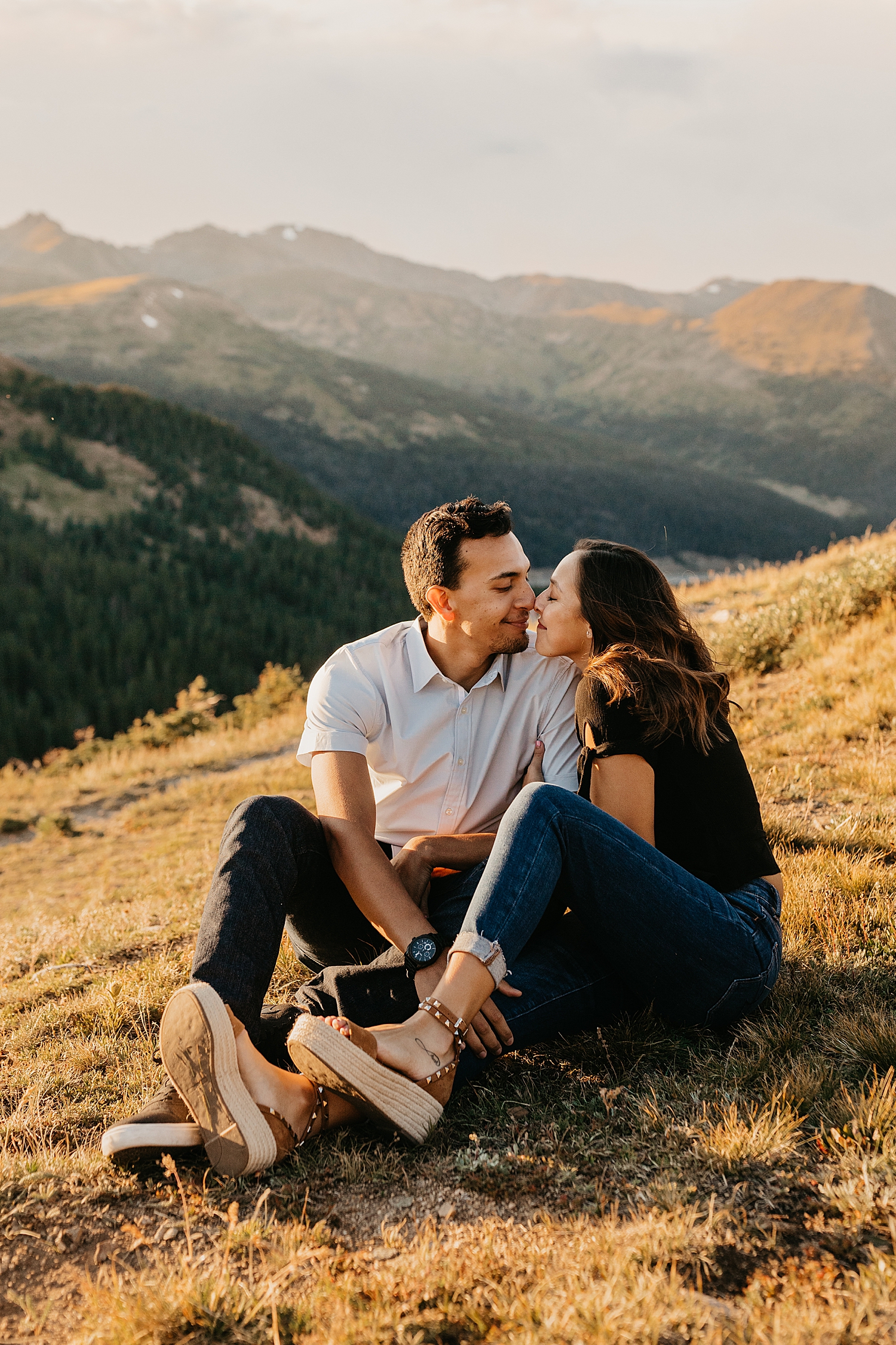 couple sits on mountainside in CO by Destination wedding photographer