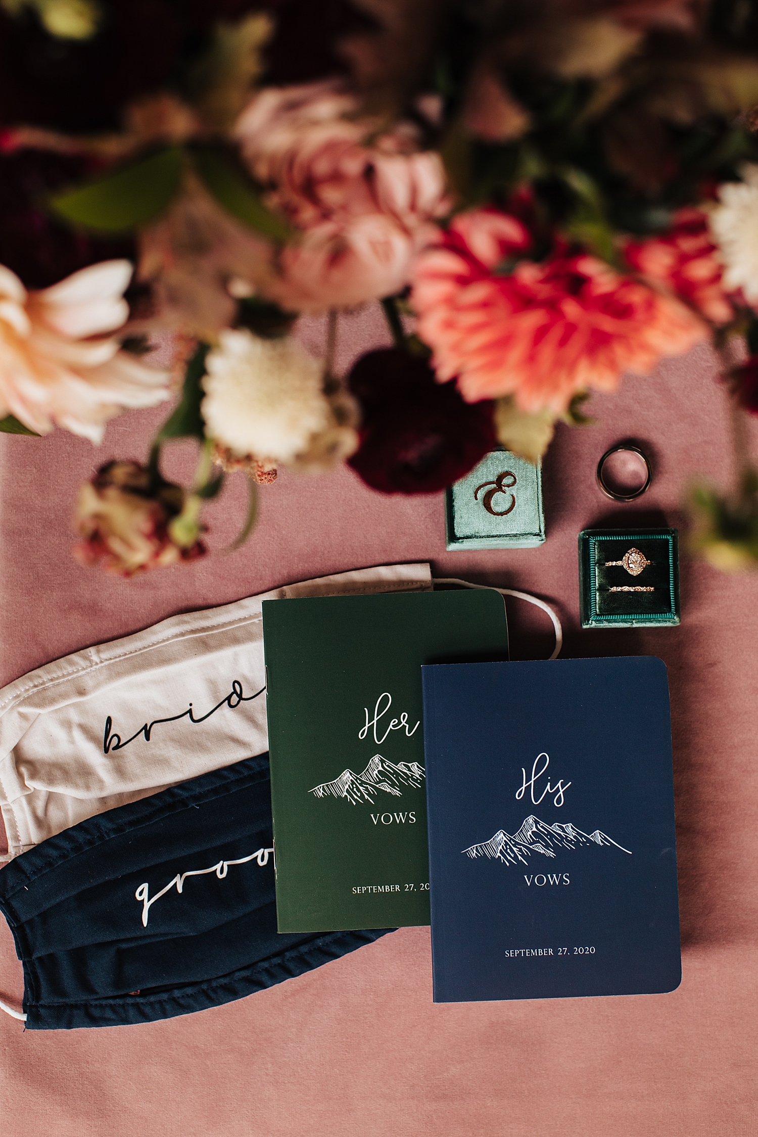 vow books over covid masks on a table by Destination wedding photographer