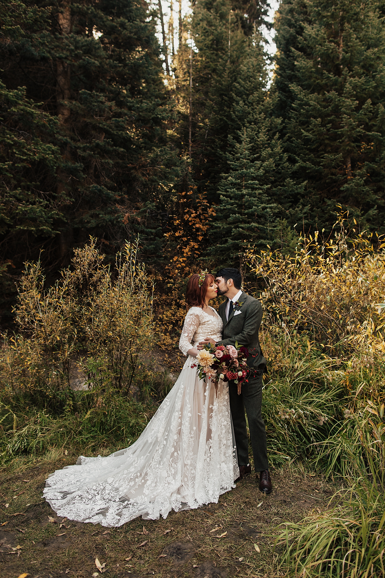 husband and wife share a kiss in fall foliage by Nicole Aston photography 
