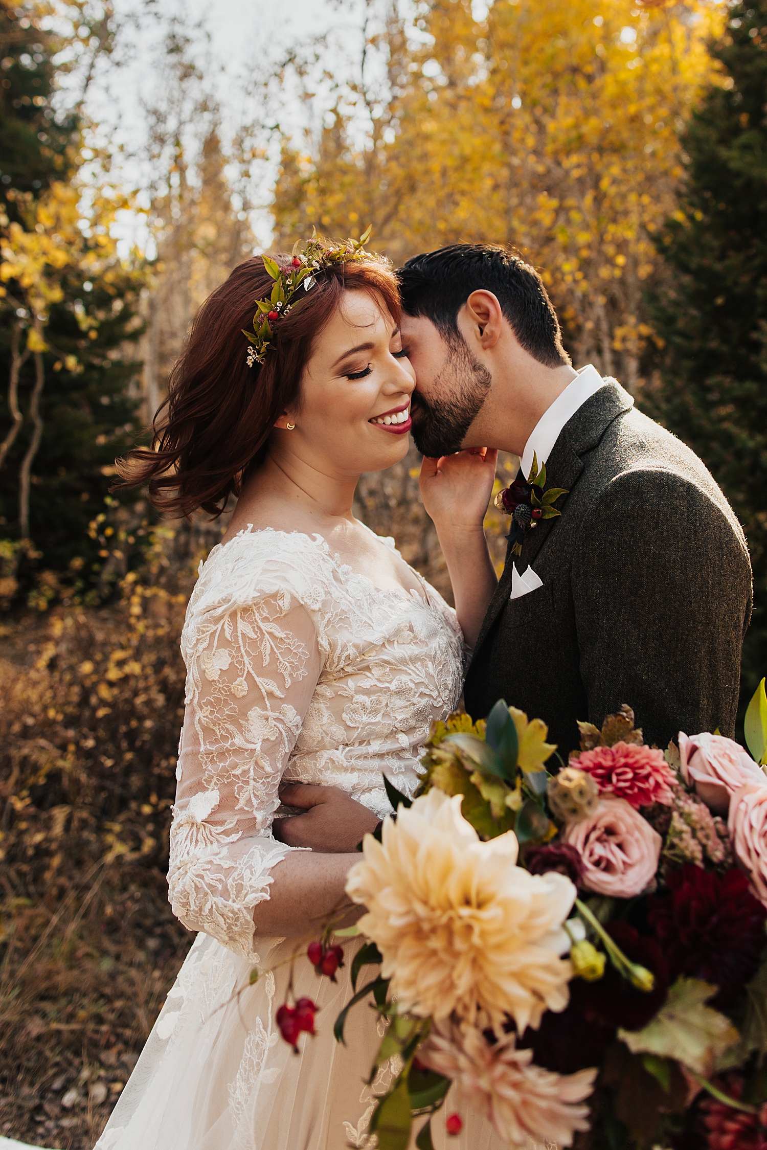 newlyweds stand in golden hour under yellow Utah trees by Nicole Aston photography 