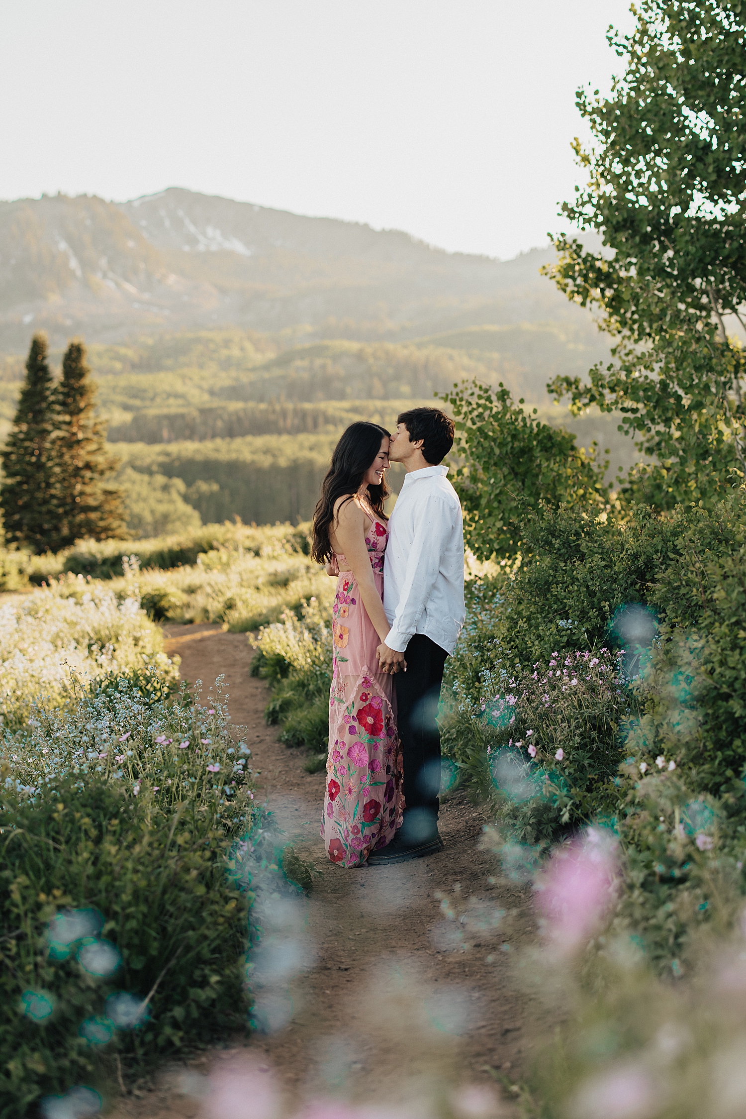 two people standing on walkway in mountains showing 10 Tips for Nailing Your Engagement Session