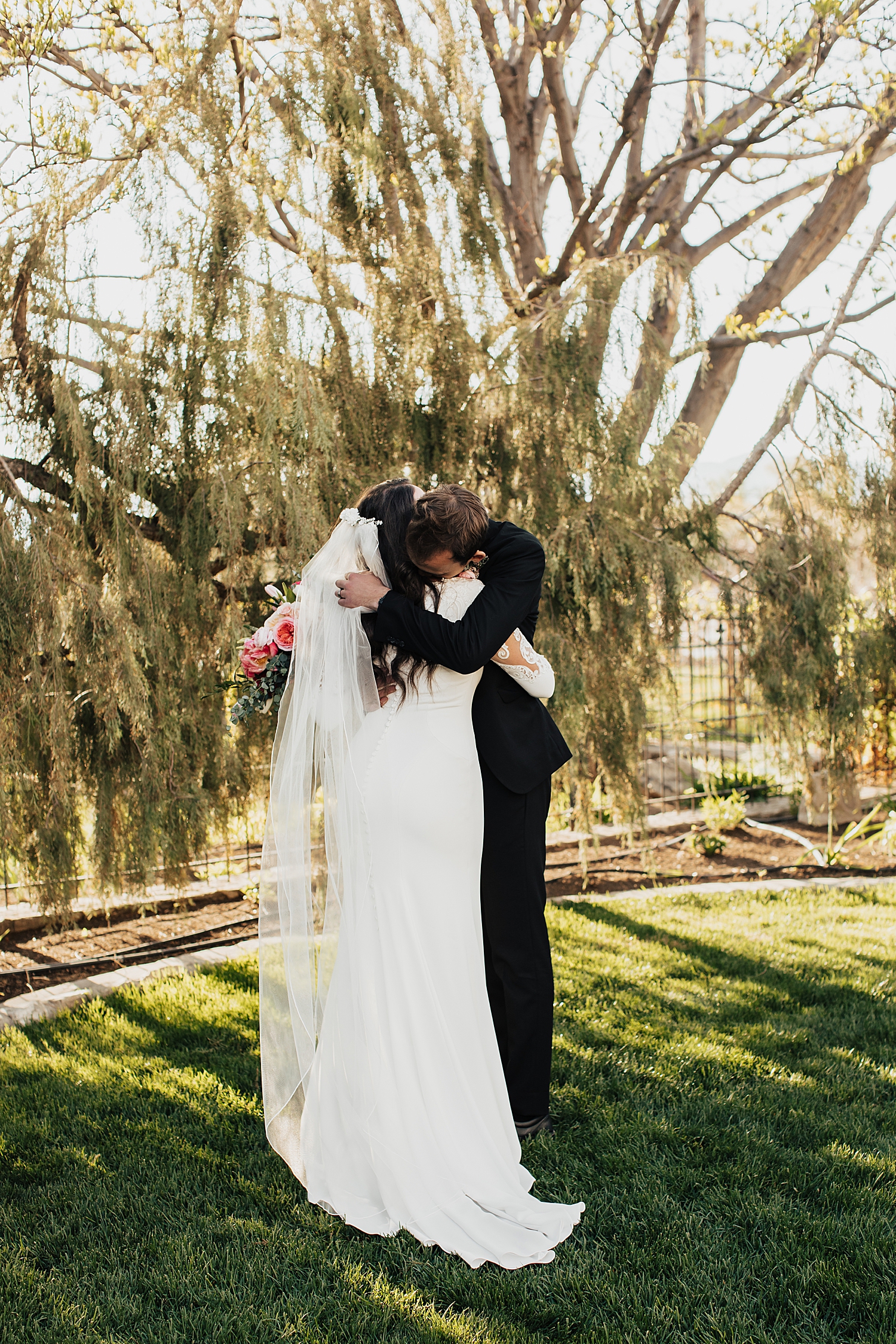 man hugs his wife-to-be after first look in garden by destination wedding photographer