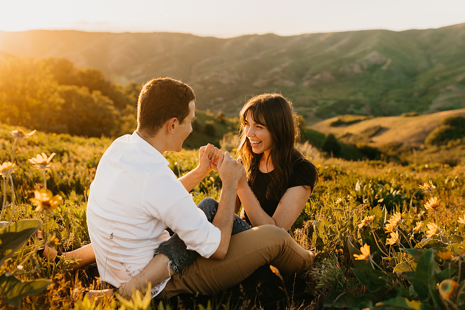 brunette sits with her man in golden hour for Salt Lake City foothills session