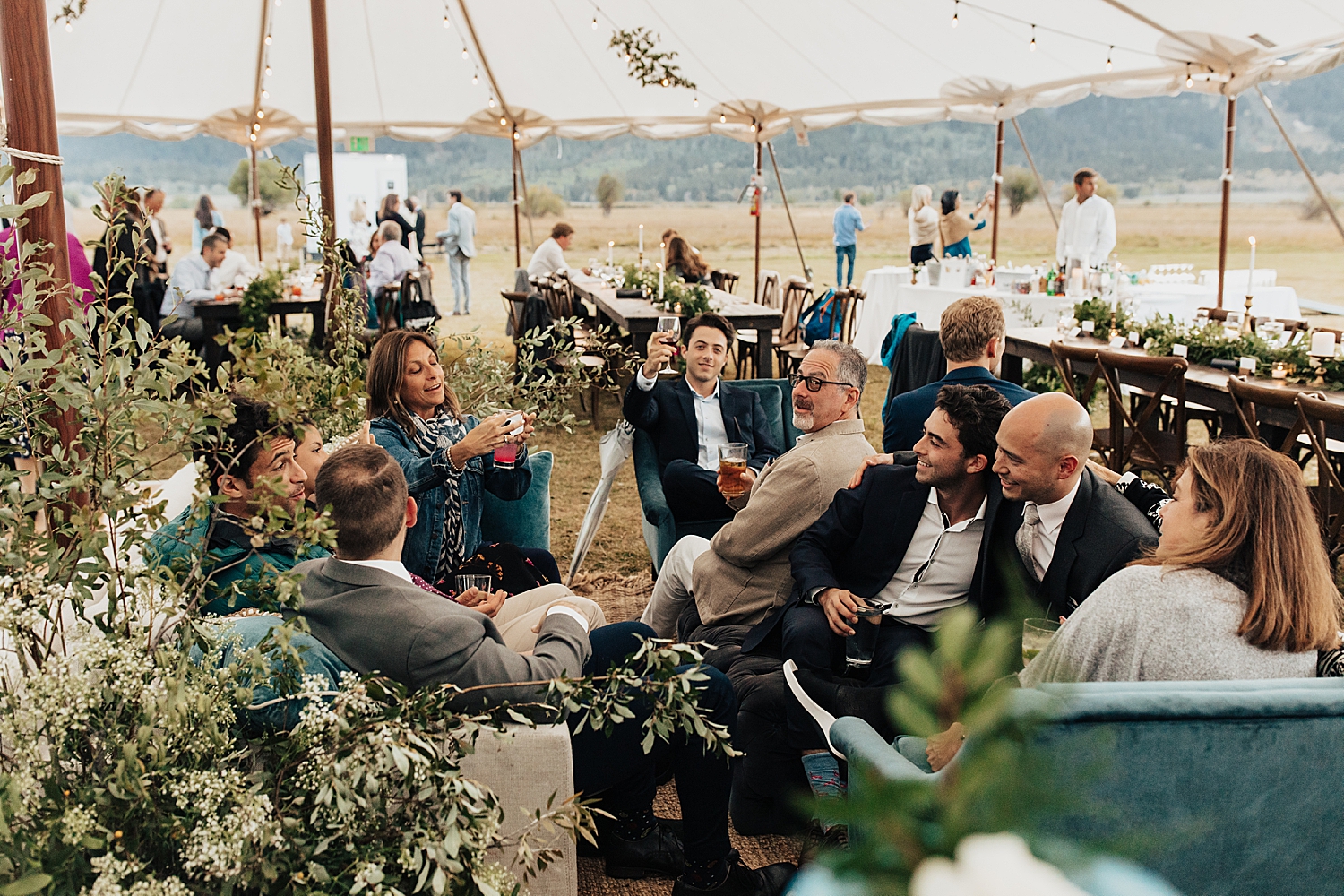 guests share a drink in velvet chairs at Snake River Ranch