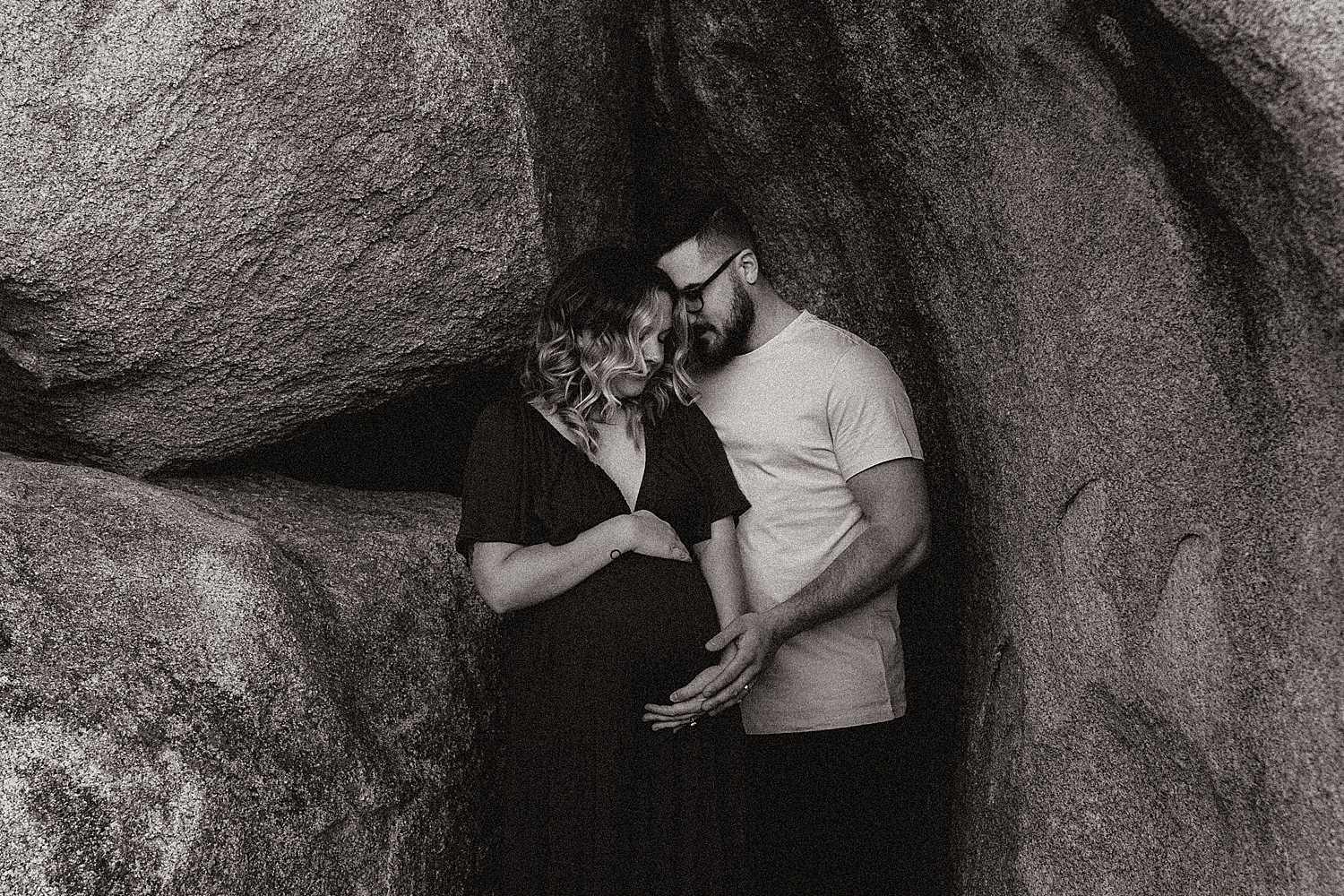 dad cradles moms bump as he leans close by Destination wedding photographer