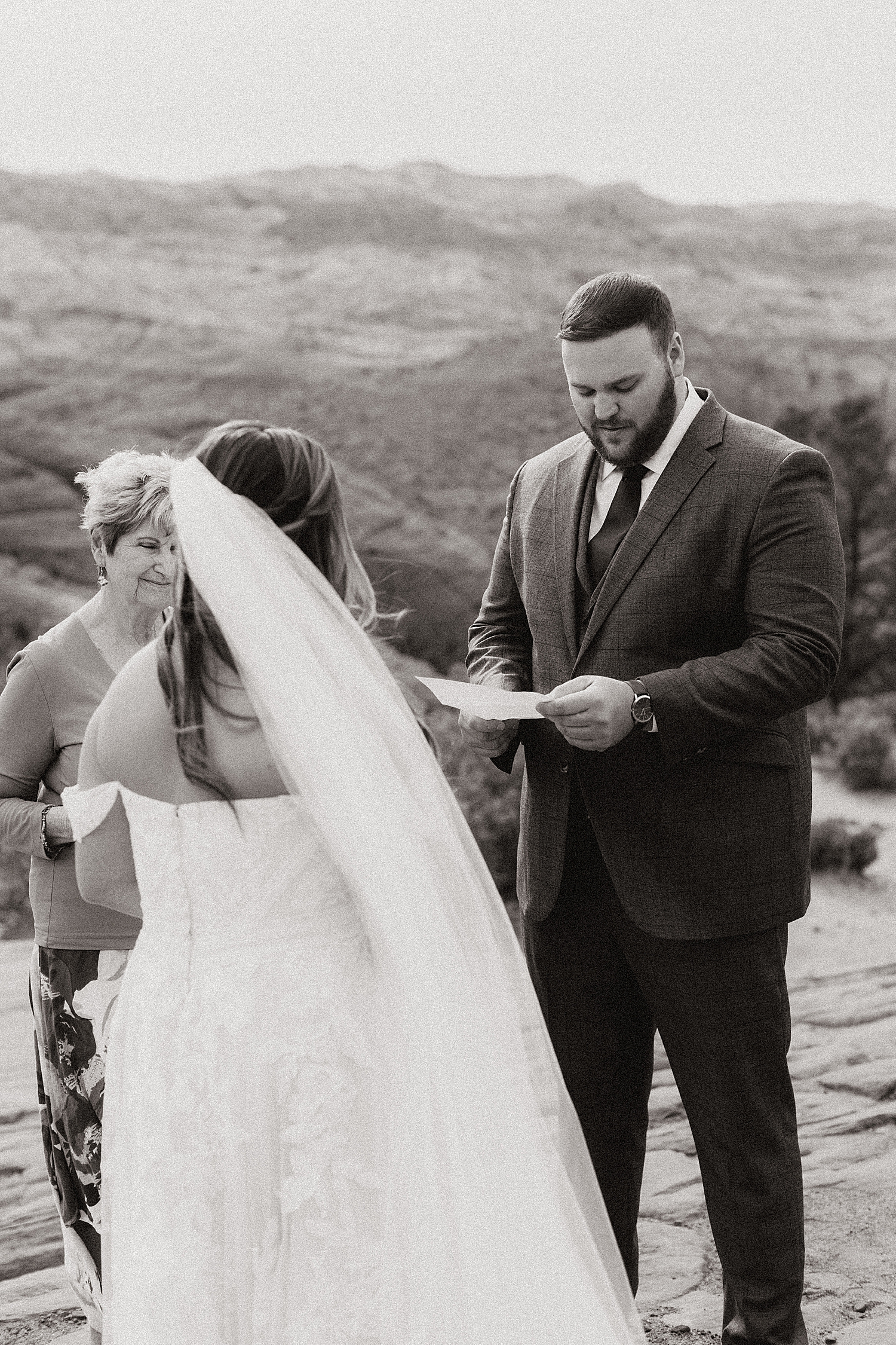 groom reads his vows in private ceremony in Snow Canyon