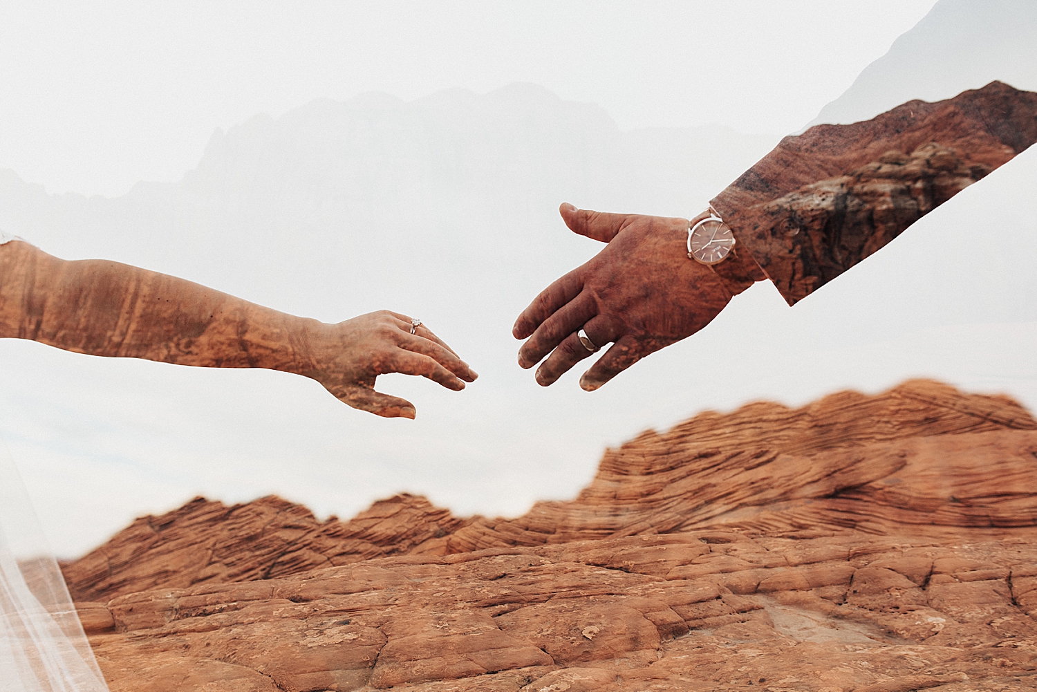 two people reach their hands out for each other at Snow Canyon