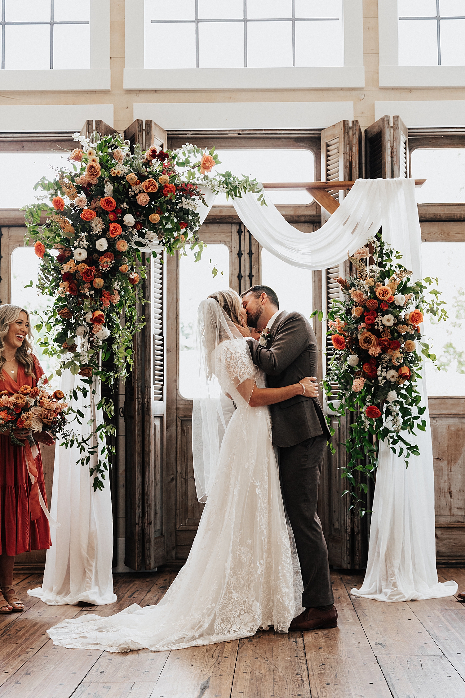 man and woman share first kiss at alter by Destination wedding photographer