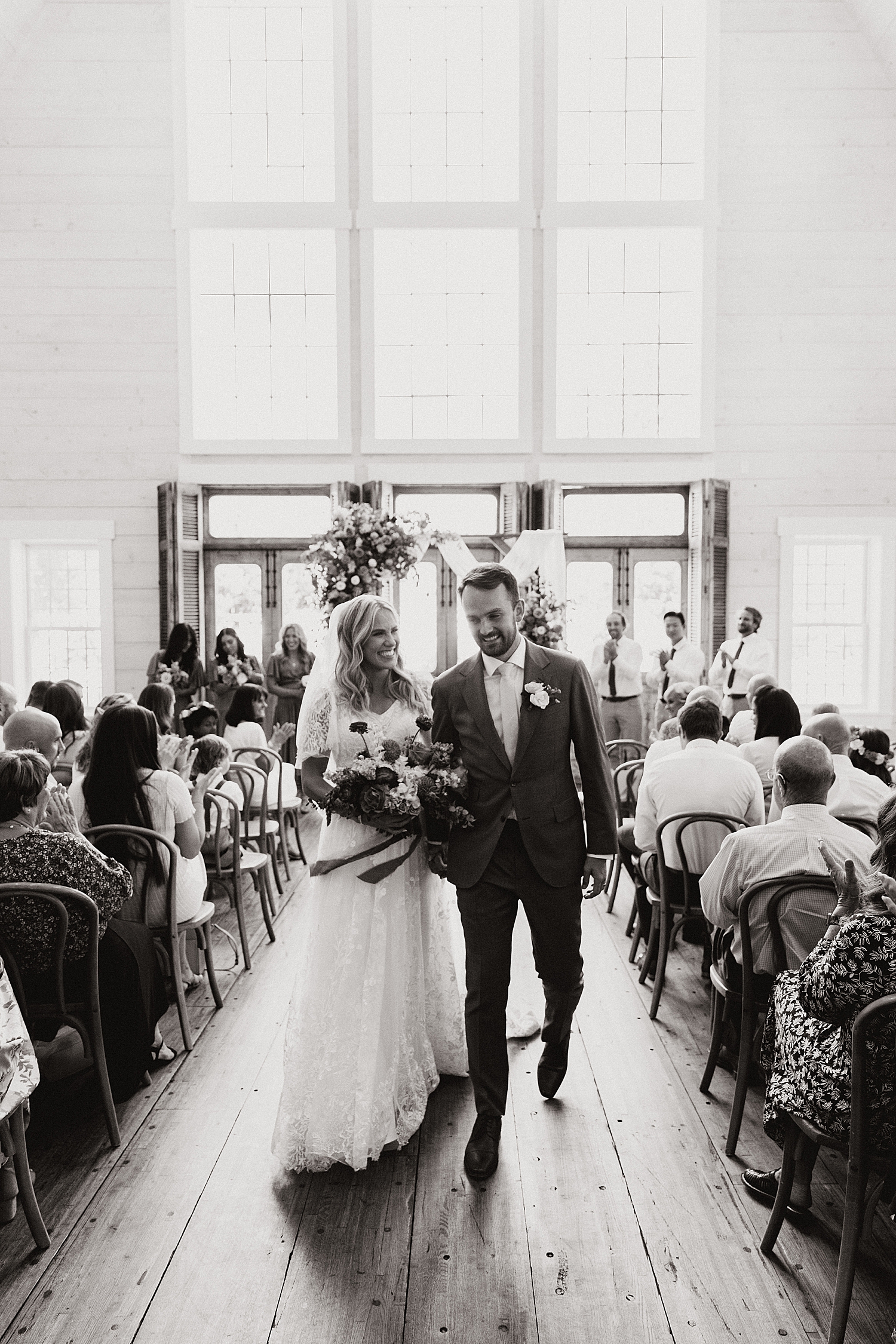 newlyweds leave their ceremony smiling by Nicole Aston Photography