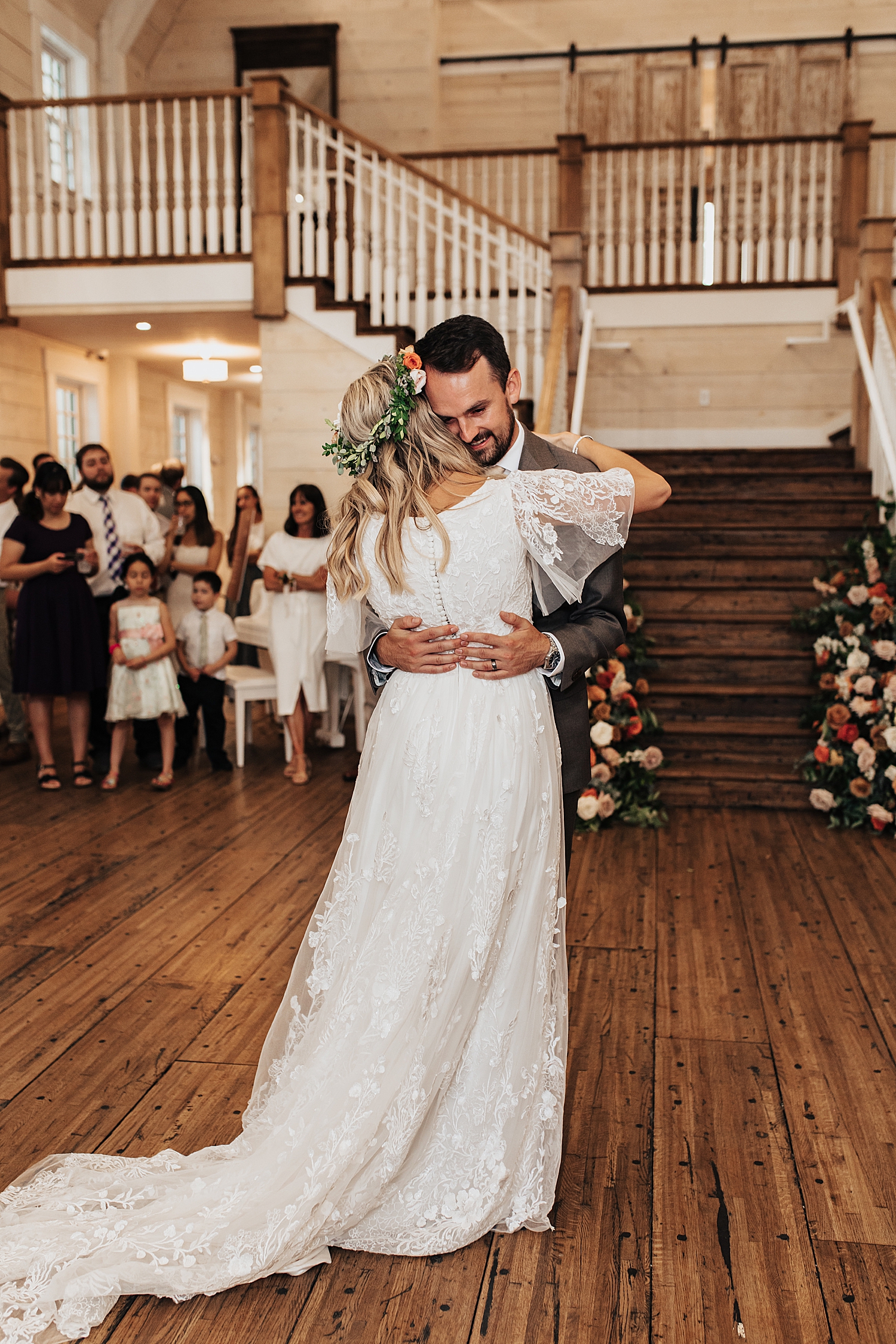 husband wraps up his new wife for a dance by Nicole Aston Photography