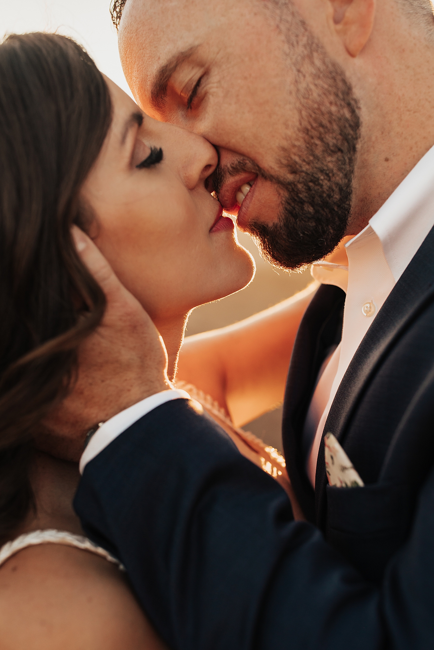 man leans in to kiss his new wife by Destination elopement photographer