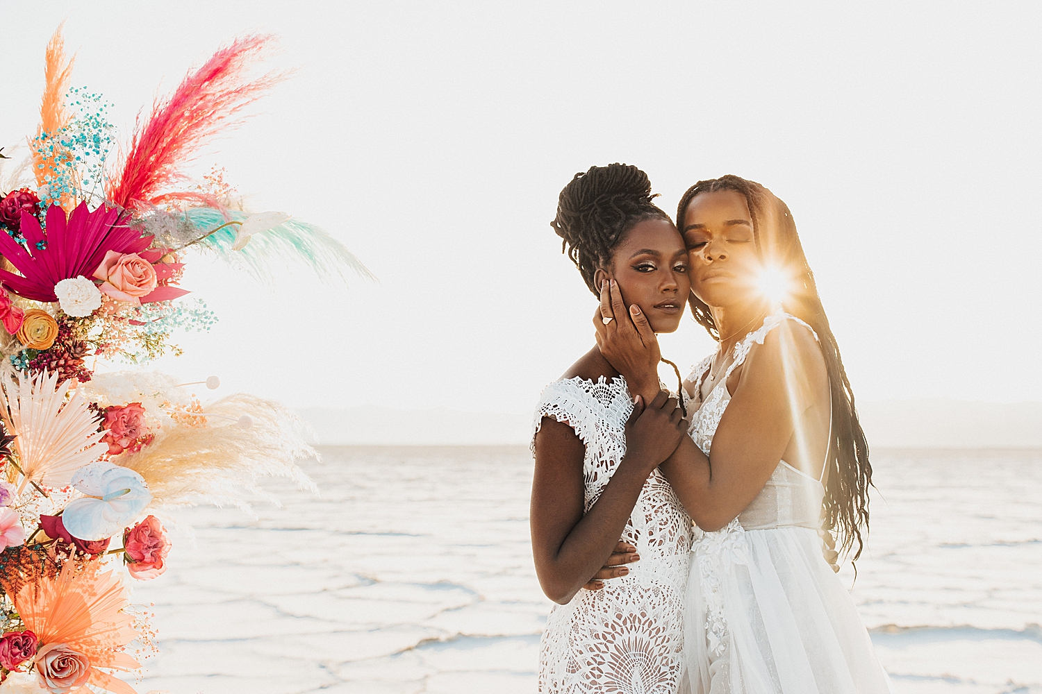 couple embrace in the setting sun in the dessert by Destination wedding photographer